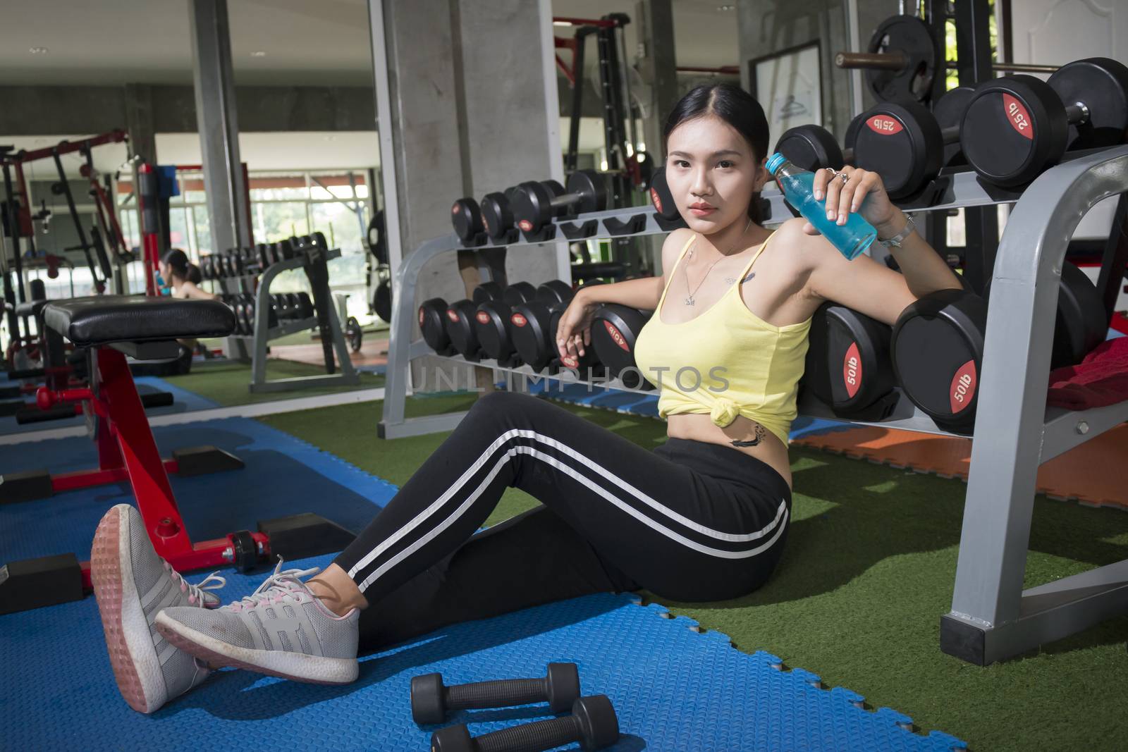 Young asian women sitting relaxing after training with Mineral drink