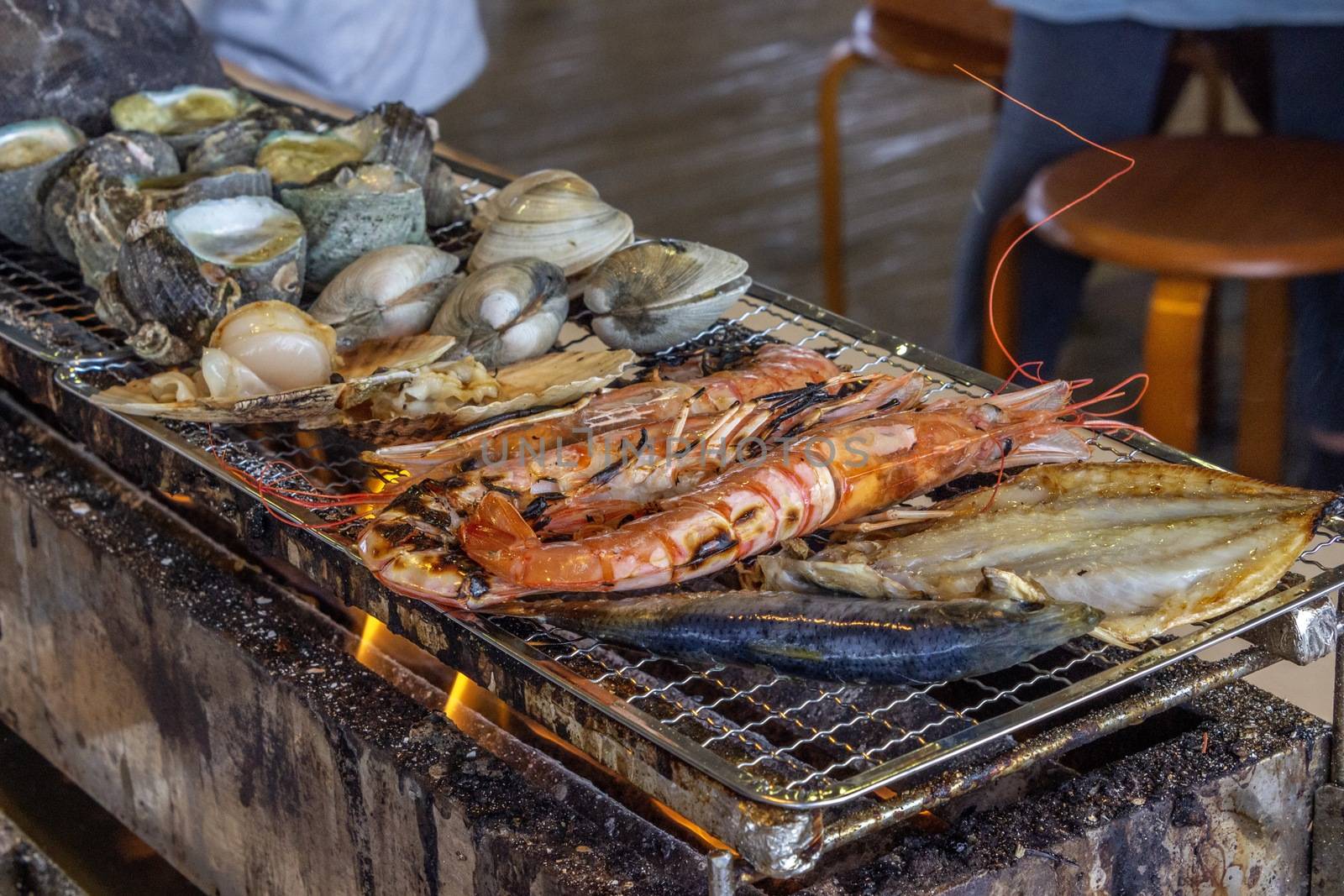 turban shell,clam,Quahog,shrimp,scallop shell,Horse mackerel, Charcoal-grilled seafood.in chiba-ken JAPAN by Umbrella