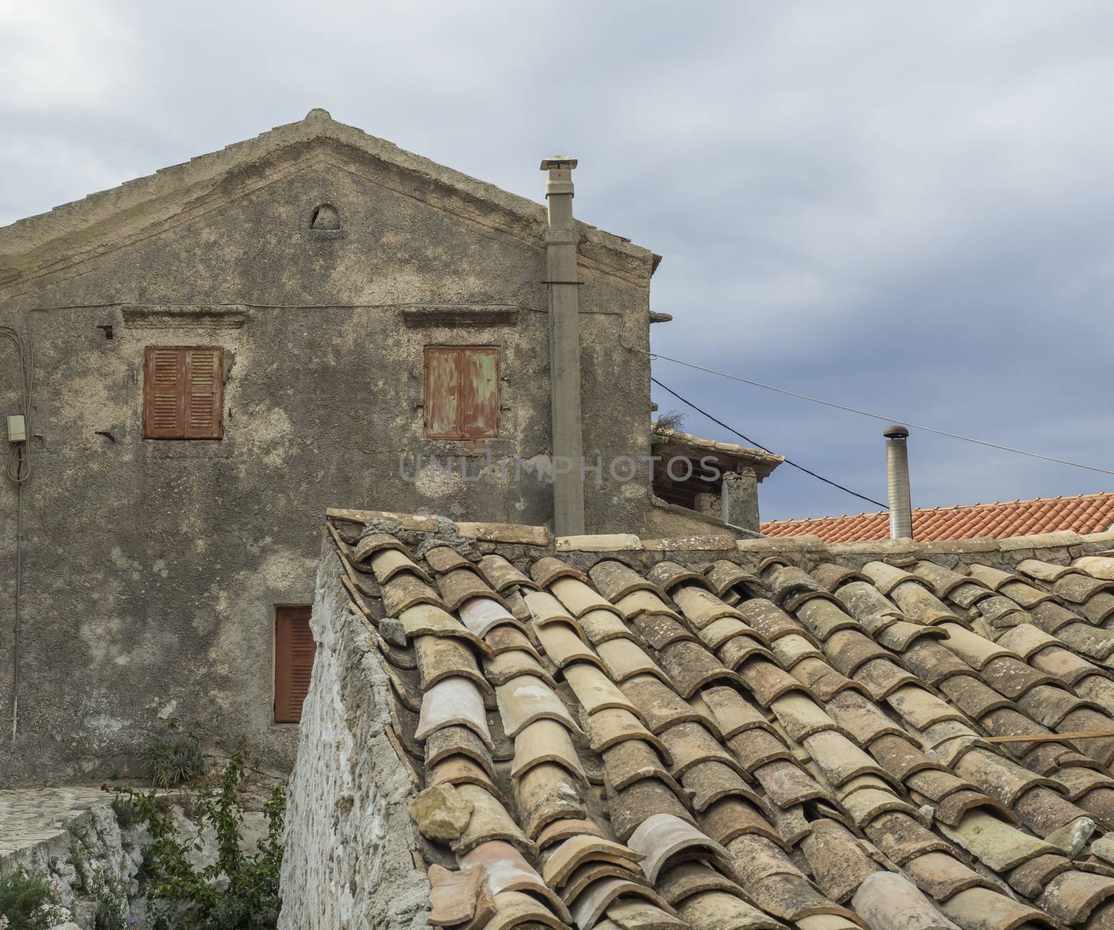 Old traditional stone house and roof in Village Krini, corfu, greece, vintage look.