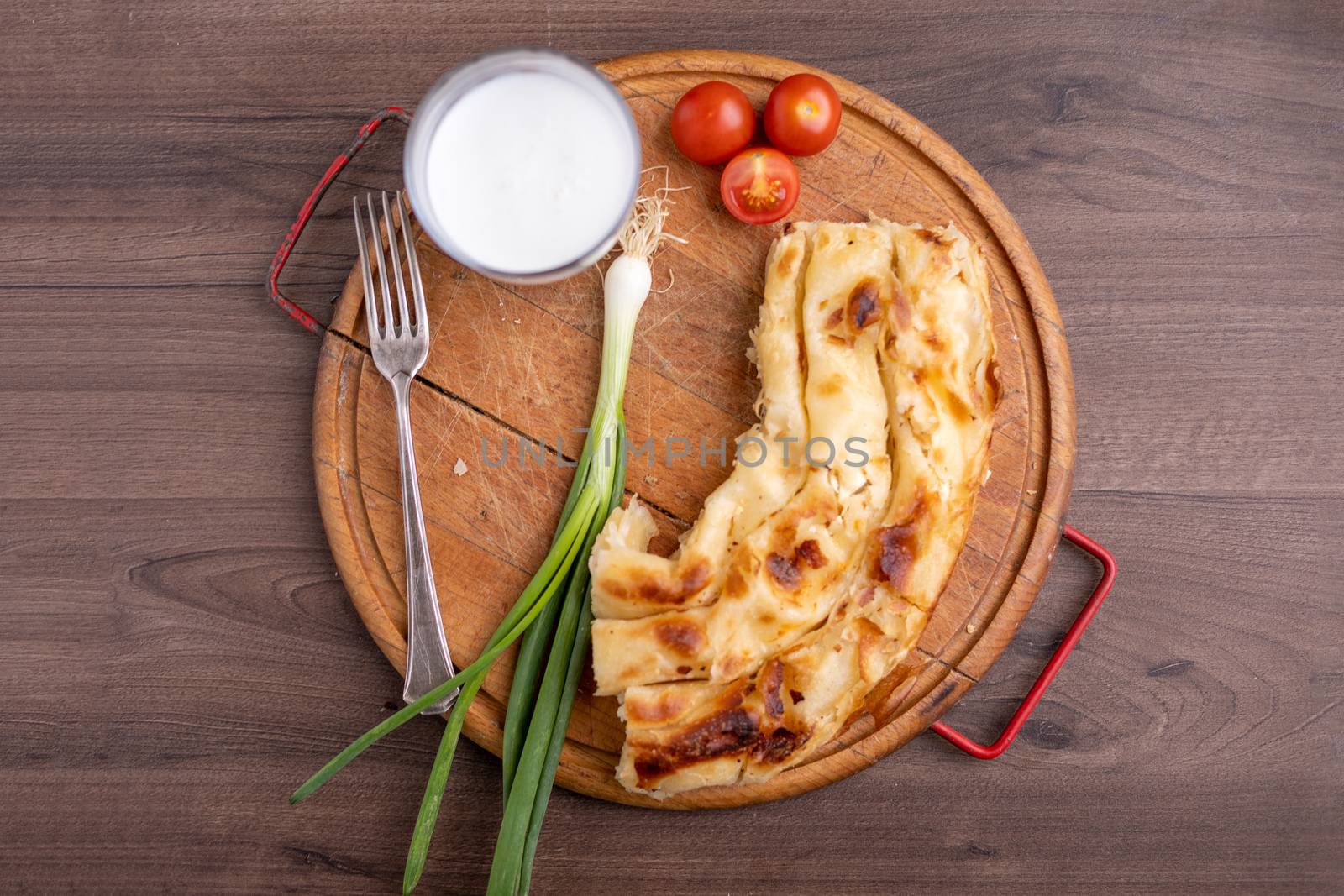 Borek or Burek pie with feta cheese aranged on wooden table