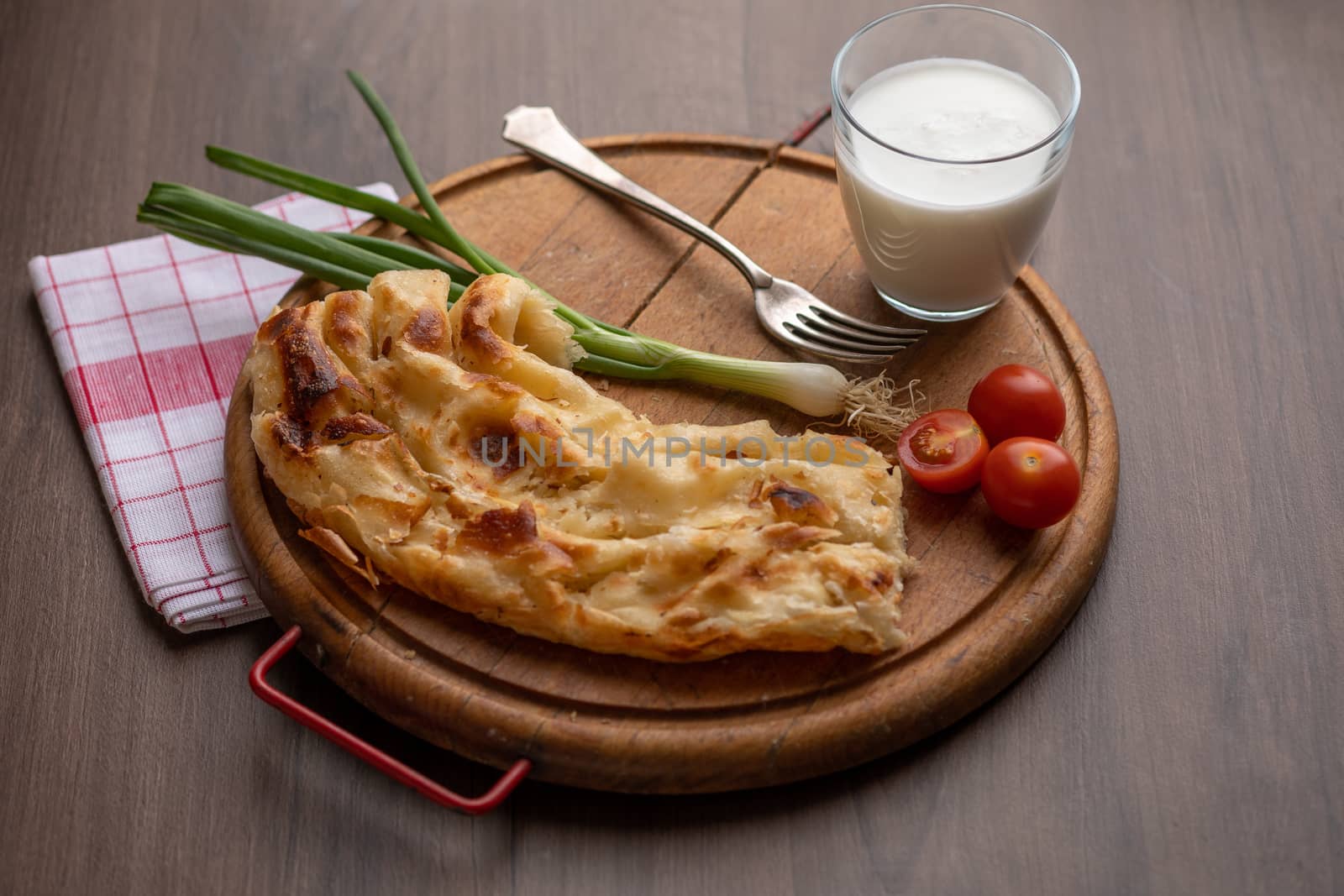 Traditional balkan breakfast - Borek or Burek pie with cheese aranged on wooden table