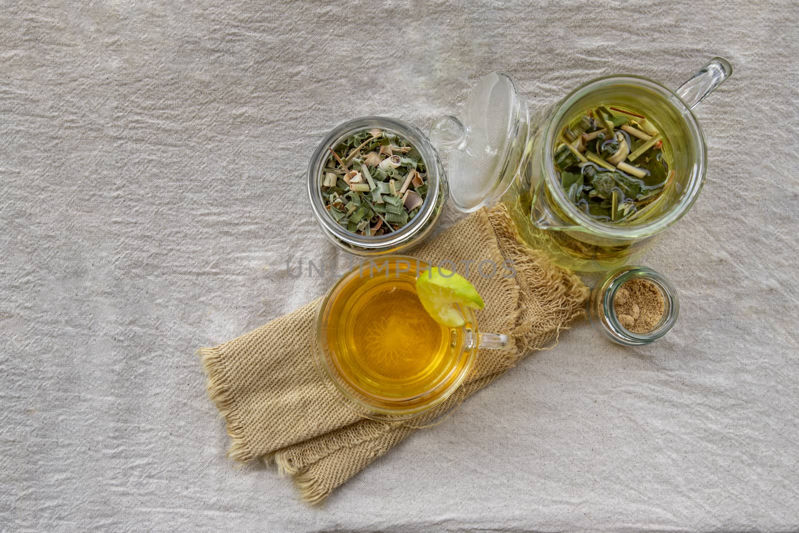 Refreshing and enjoy with A cup of lemongrass pandan tea served with brown sugar In the afternoon on white table. Thai herbal plant and healthy drinks concept. Top view, Selective focus, Copy space.