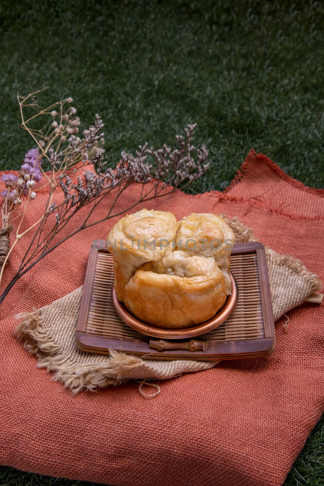 Traditional homemade bread thai : Coconut Bread bake on wooden tray. One piece, Selective focus.