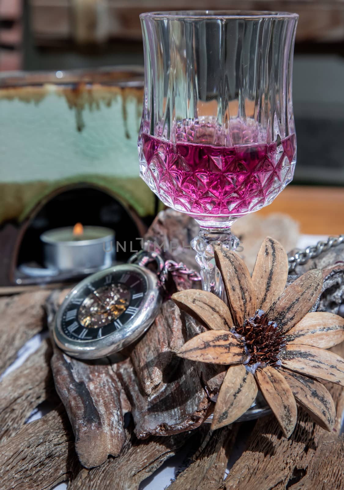 Grape juice with A retro pocket watch on wooden background. The concept of relaxing and reminiscing old memories.