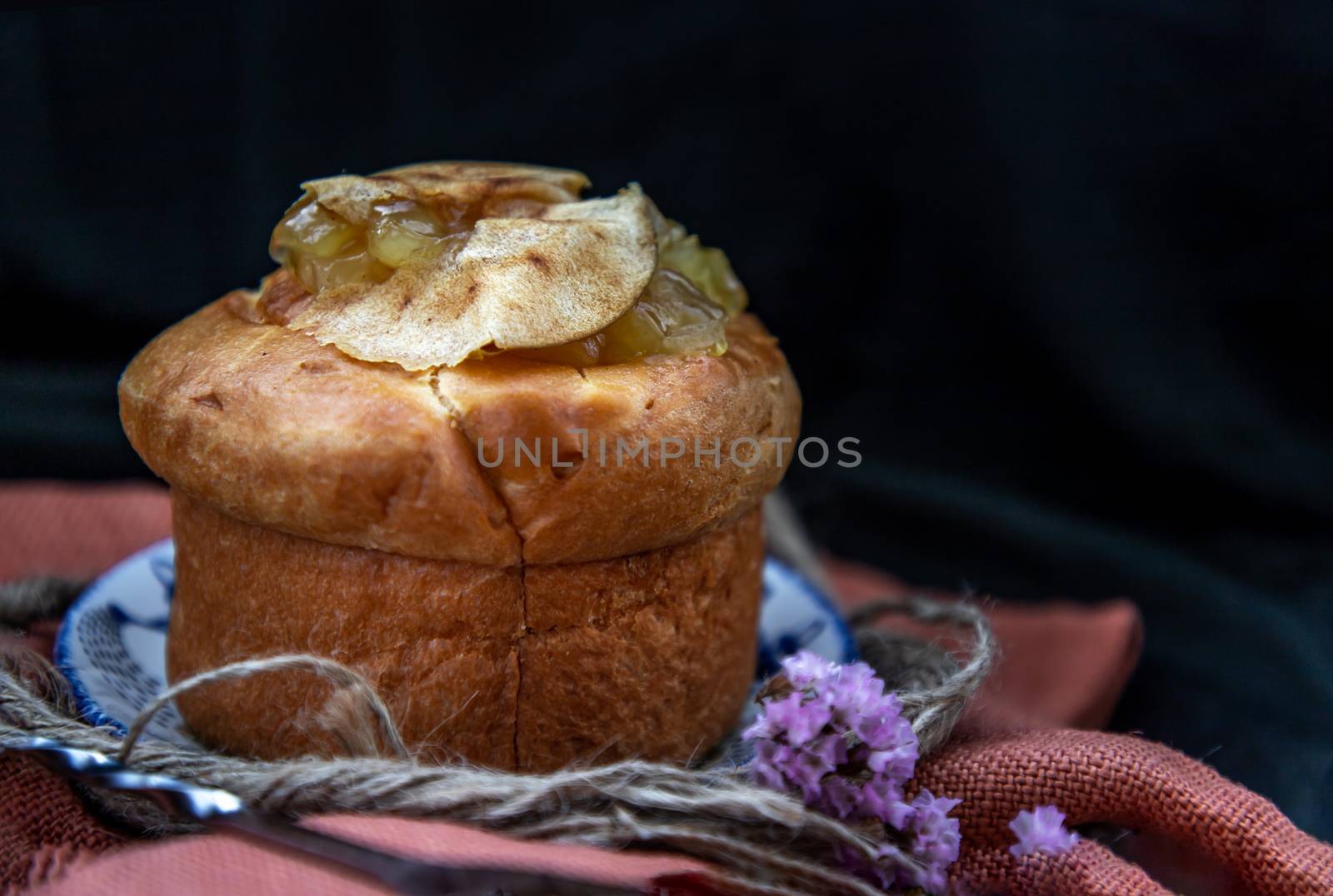 Traditional French sweet dessert : Apple Brioche on beautiful background. One piece. Delicious seasonal breakfast. Oblique view from the top, Selective focus.