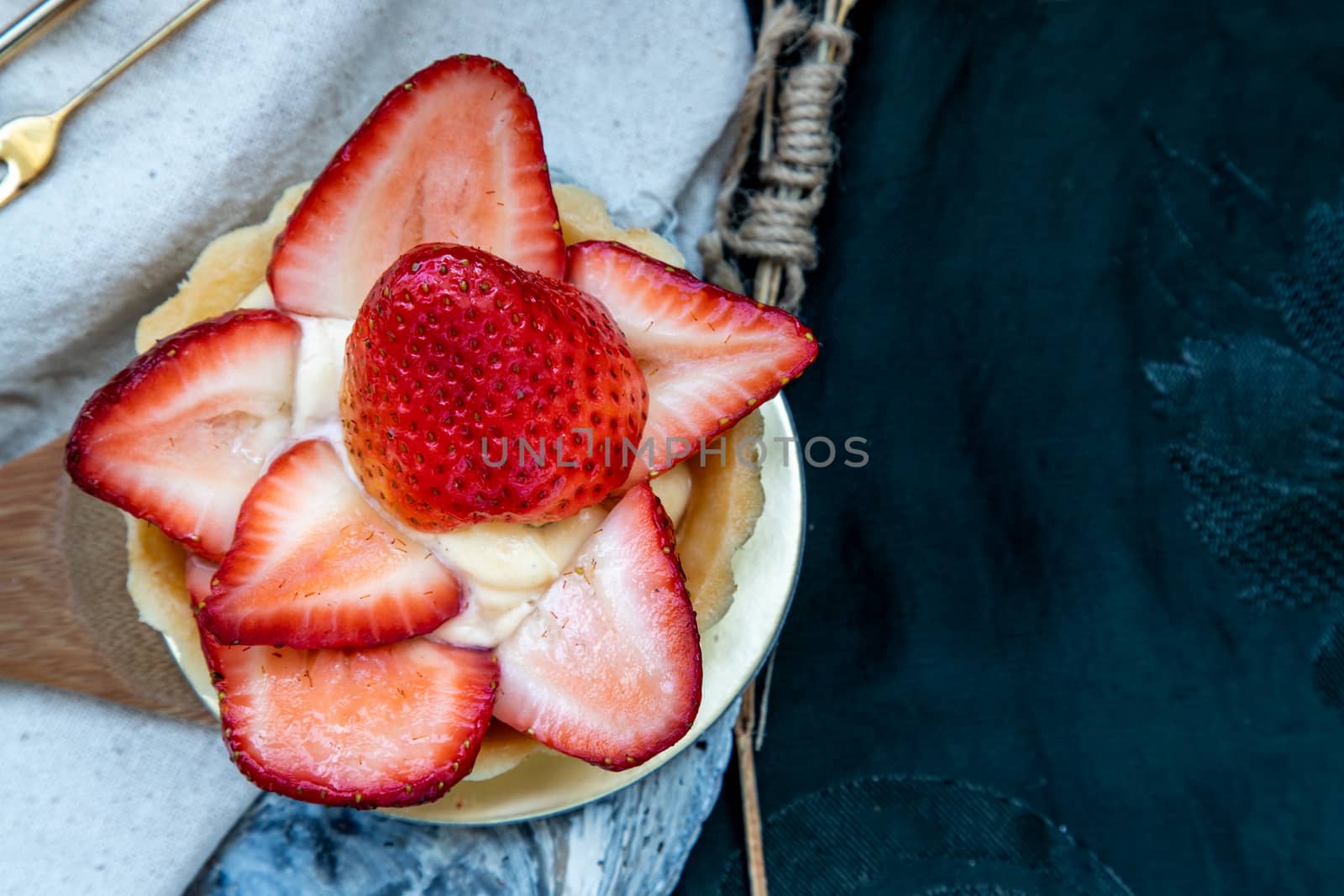 Traditional French sweet dessert : Strawberry tart on beautiful background. One piece, Delicious seasonal breakfast. Top view, Selective focus.