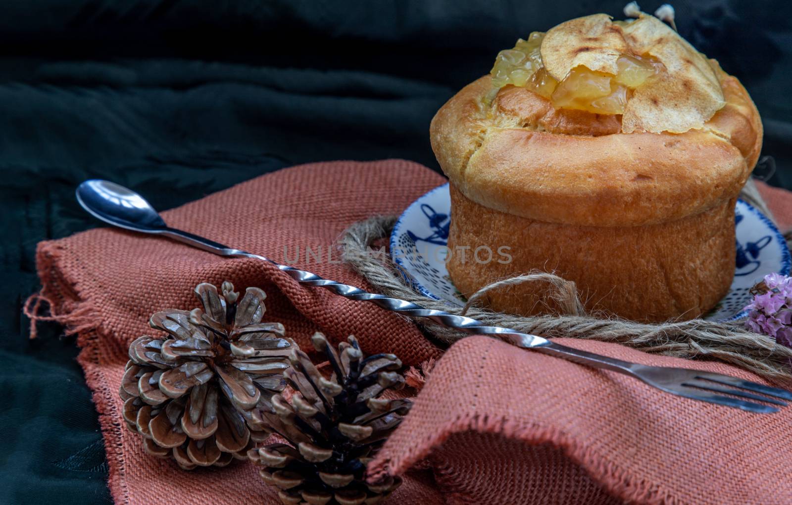 Traditional French sweet dessert : Apple Brioche on beautiful background. One piece. Delicious seasonal breakfast. Oblique view from the top, Selective focus.