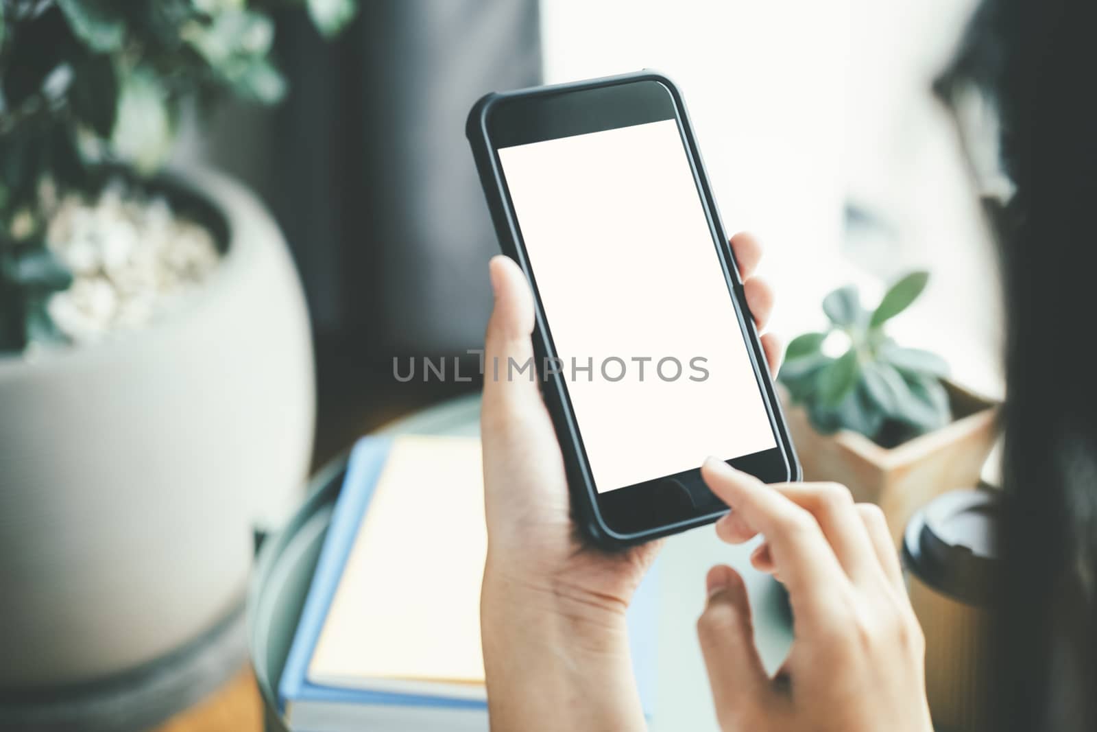 Close up of woman hand holding smart phone. Blank screen mockup for graphics display montage.