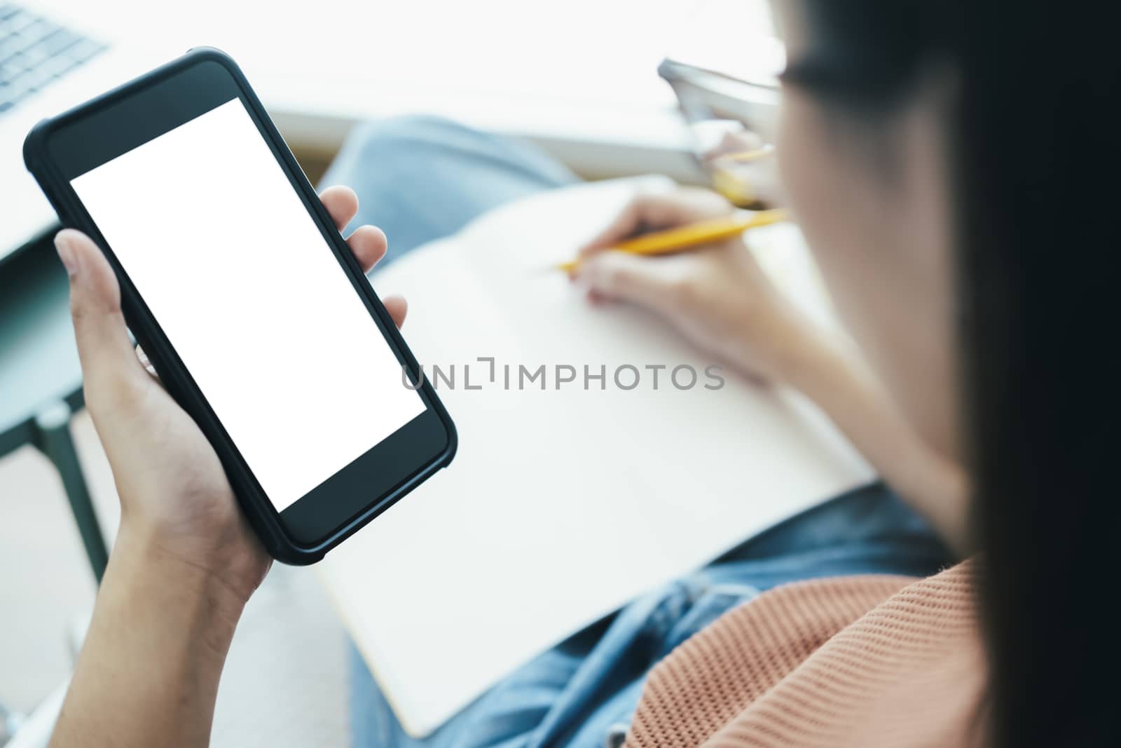Close up of woman hand holding smart phone. Blank screen mockup for graphics display montage.