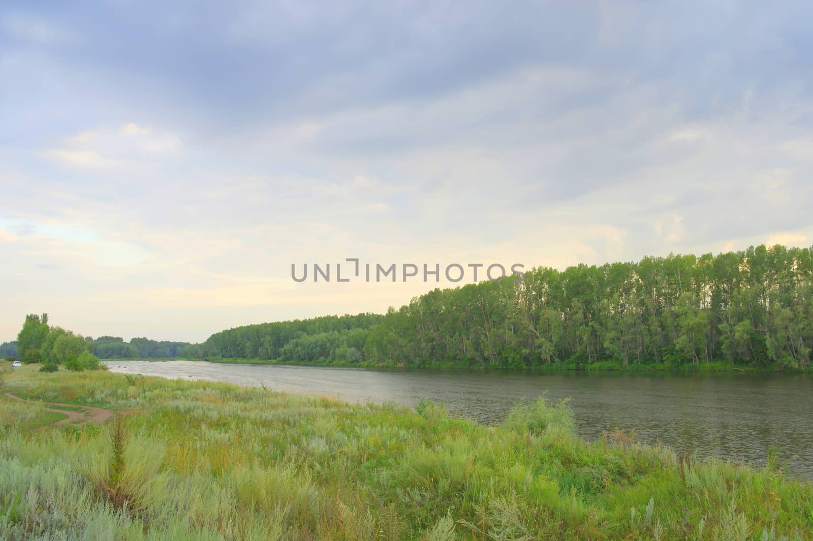 beautiful summer landscape with river and dramatic sky
