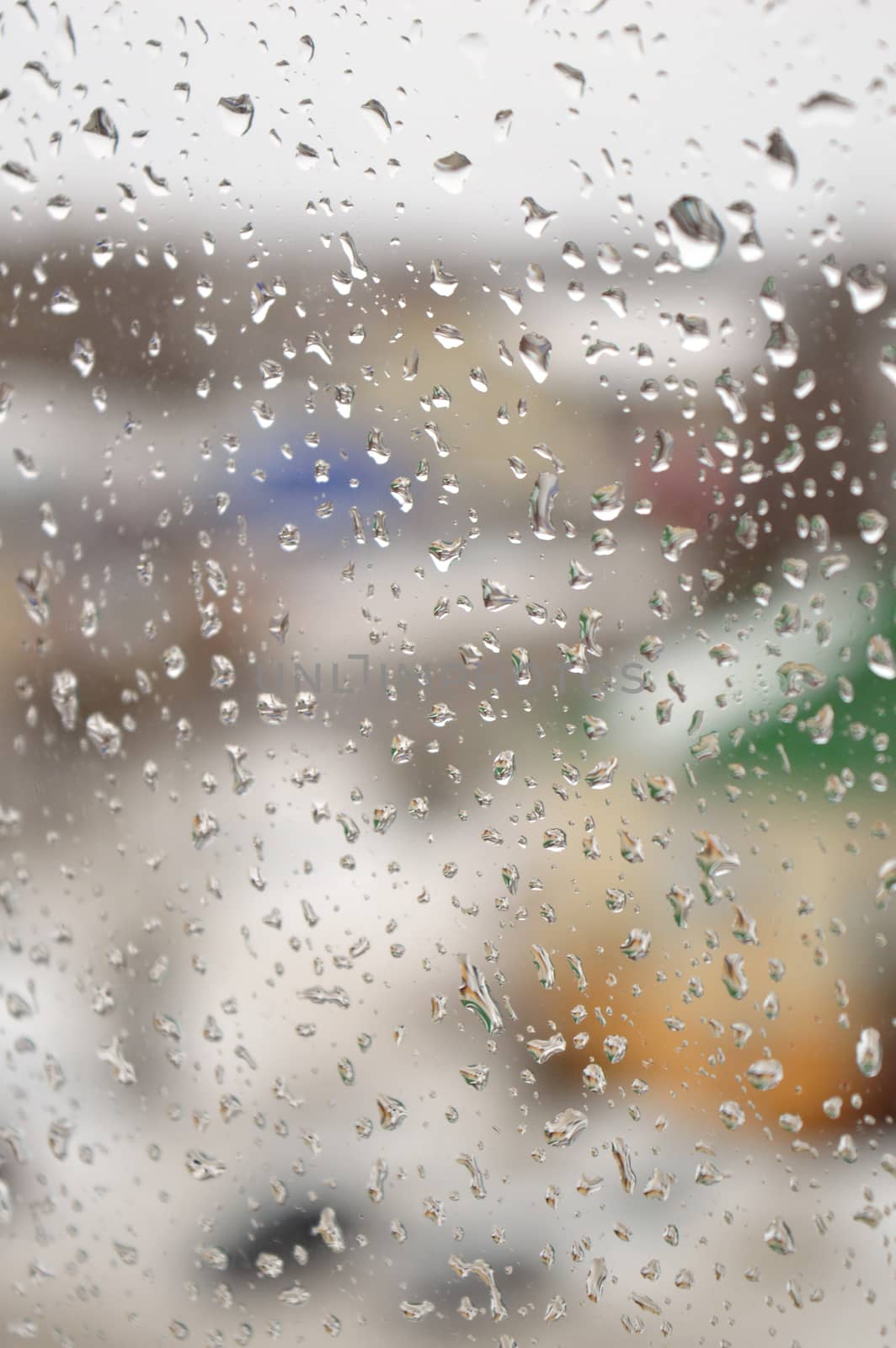 Drops of rain on the window, rainy day. Shallow DOF