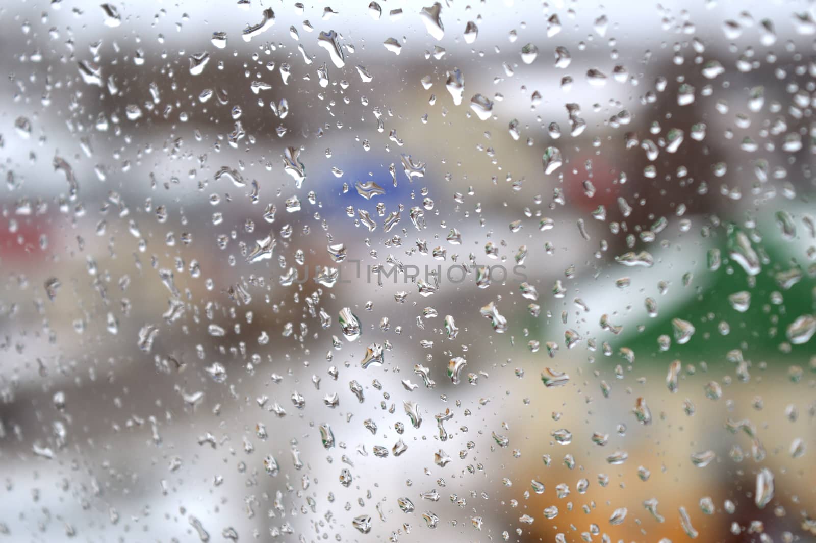 Drops of rain on the window, rainy day. Shallow DOF