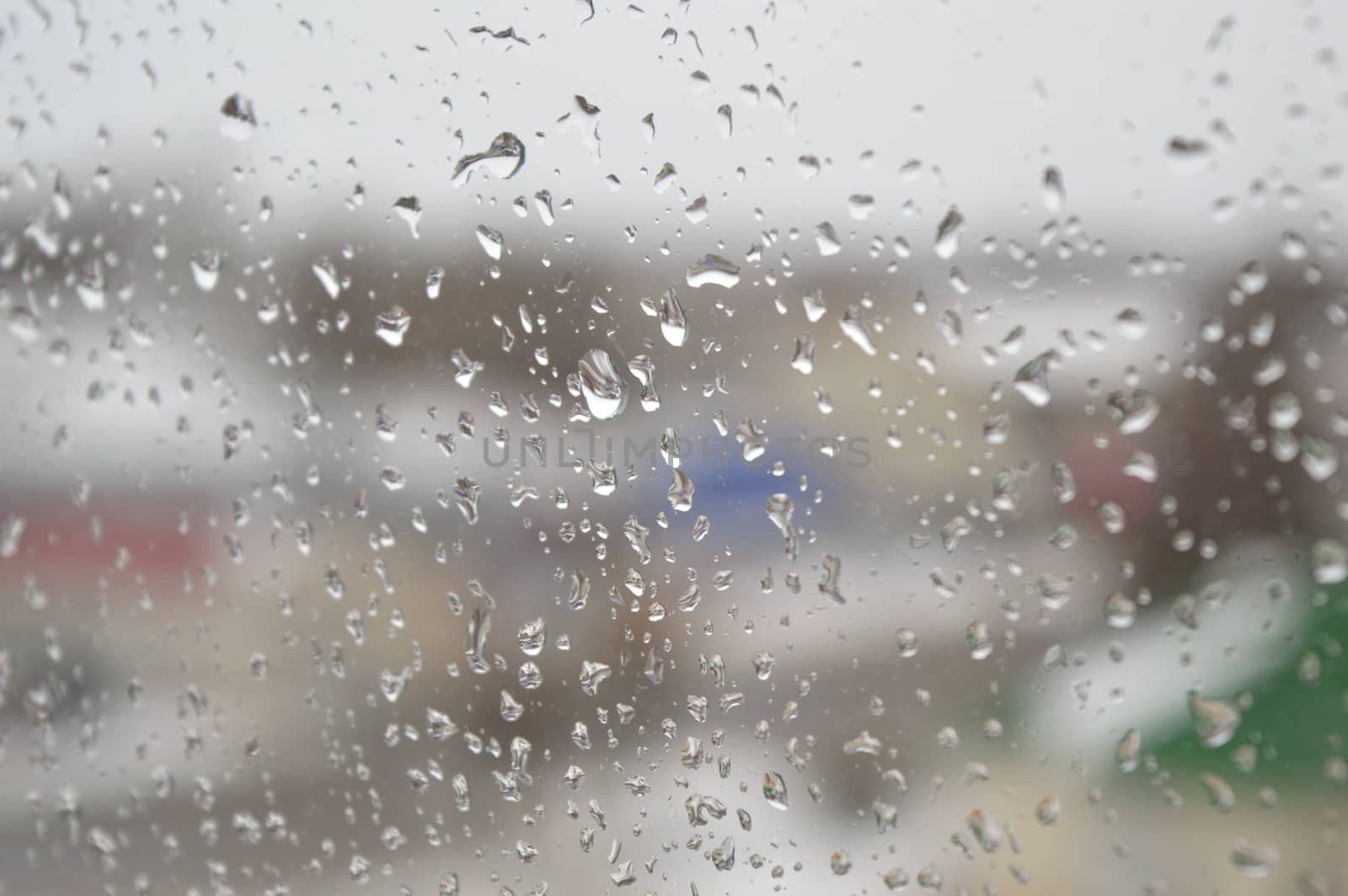 Drops of rain on the window, rainy day. Shallow DOF