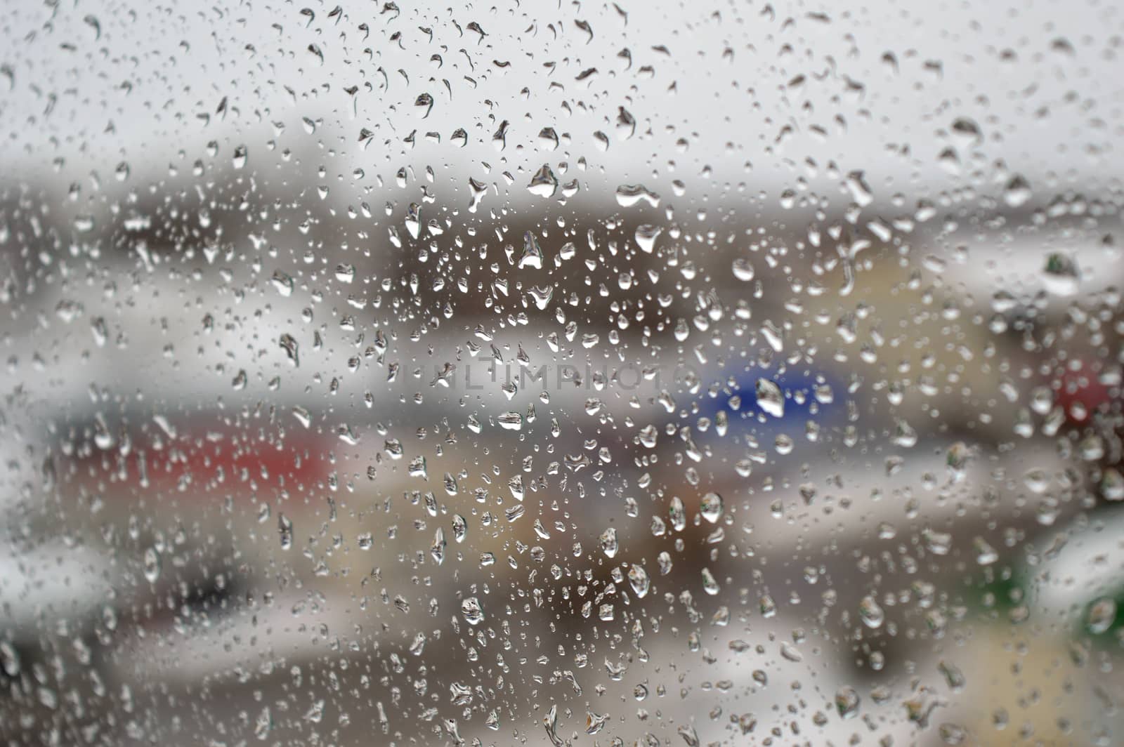 Drops of rain on the window, rainy day. Shallow DOF