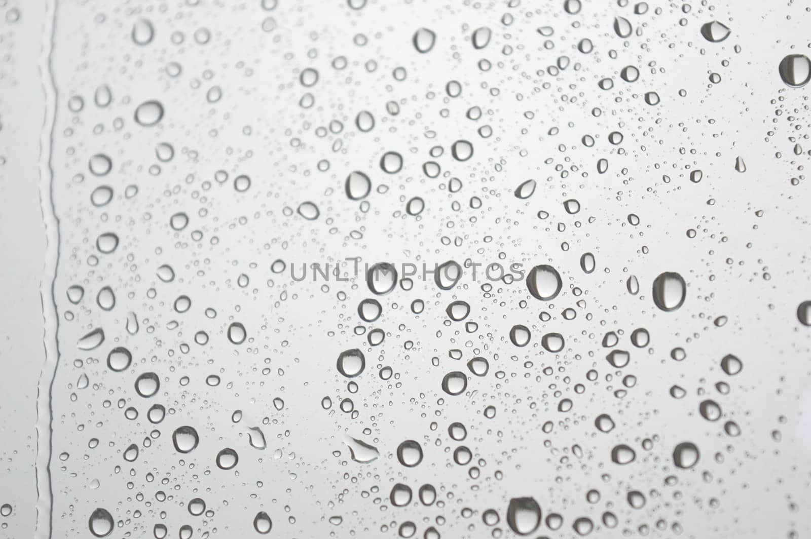 Drops of rain on the window, rainy day. Shallow DOF