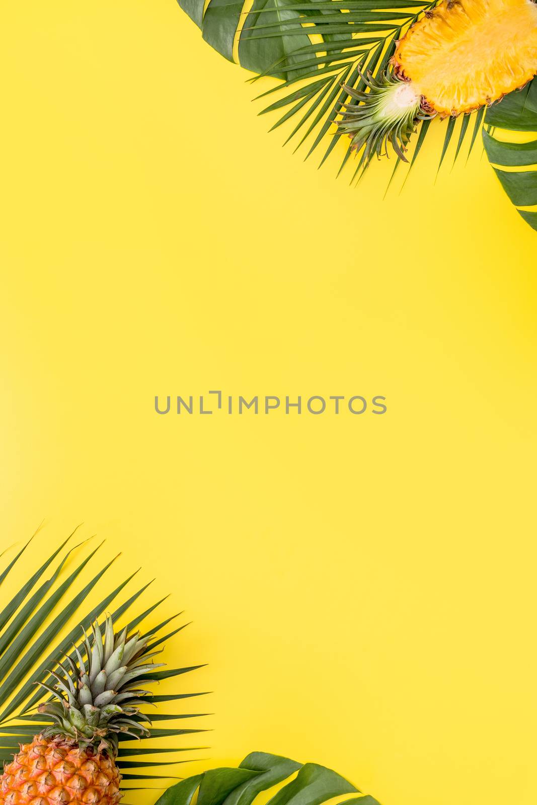 Beautiful pineapple on tropical palm monstera leaves isolated on by ROMIXIMAGE