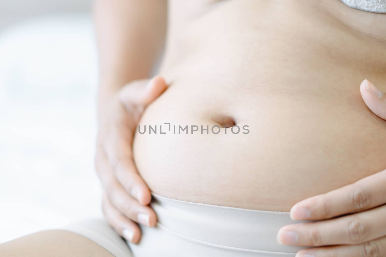 Closeup hand holding abdominal surface woman fat, healthy care and beauty concept