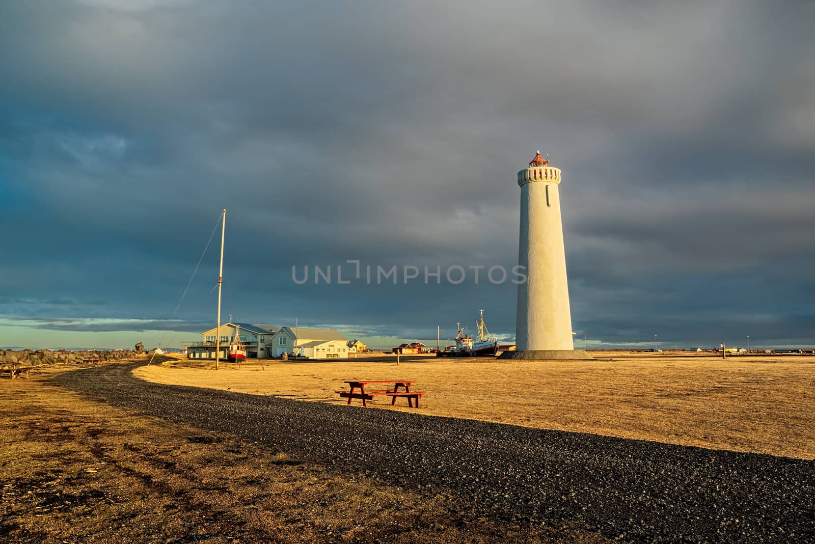Gardur lighthouse and old ships at sunset, Iceland