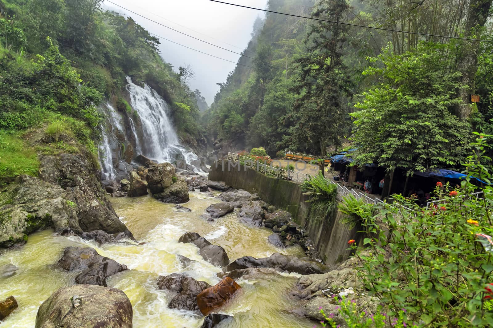 Waterfall cascade in jungle cliffs rock mountain river motion