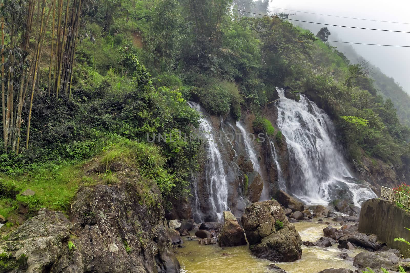 Waterfall cascade in jungle cliffs rock mountain river motion by Vladyslav