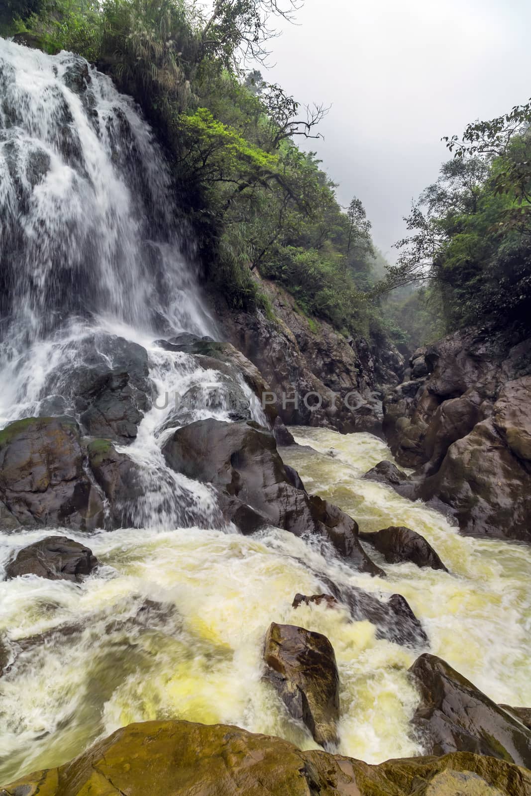 Waterfall cliffs rock mountain river motion. Landscape Sapa in Lao Cai Province in Vietnam.