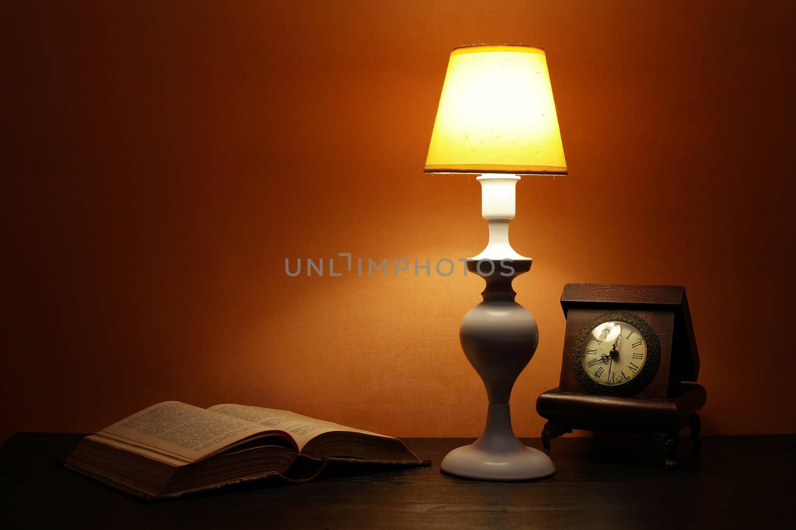 Elegance white desk lamp with yellow lampshade near open book
