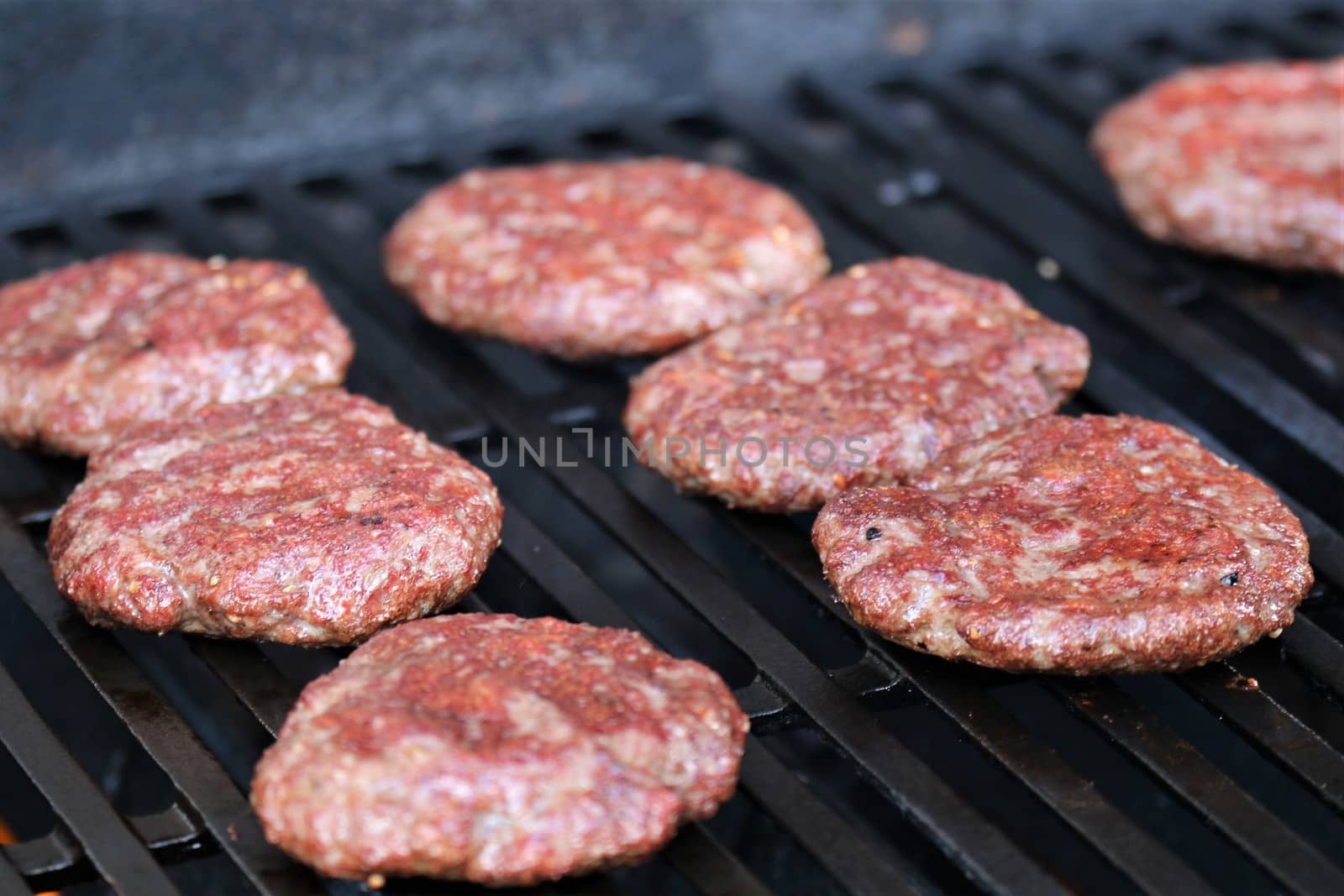 Several minced steaks on the grill