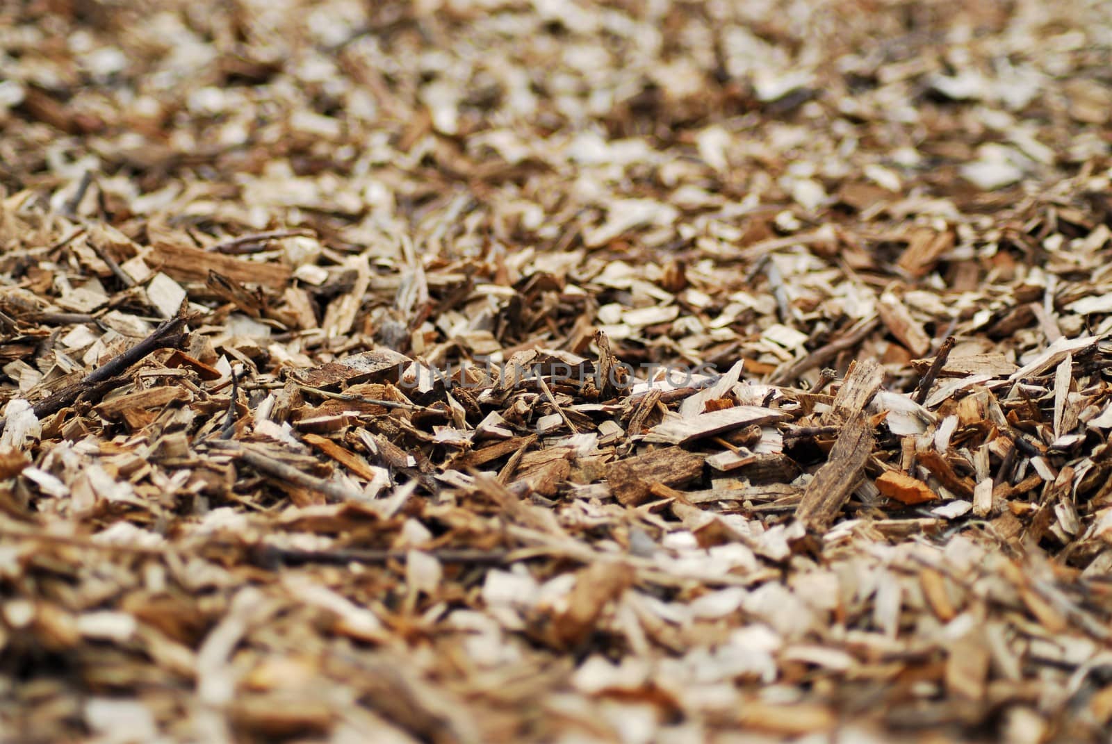 A close up of brown wood chips on a sunny day