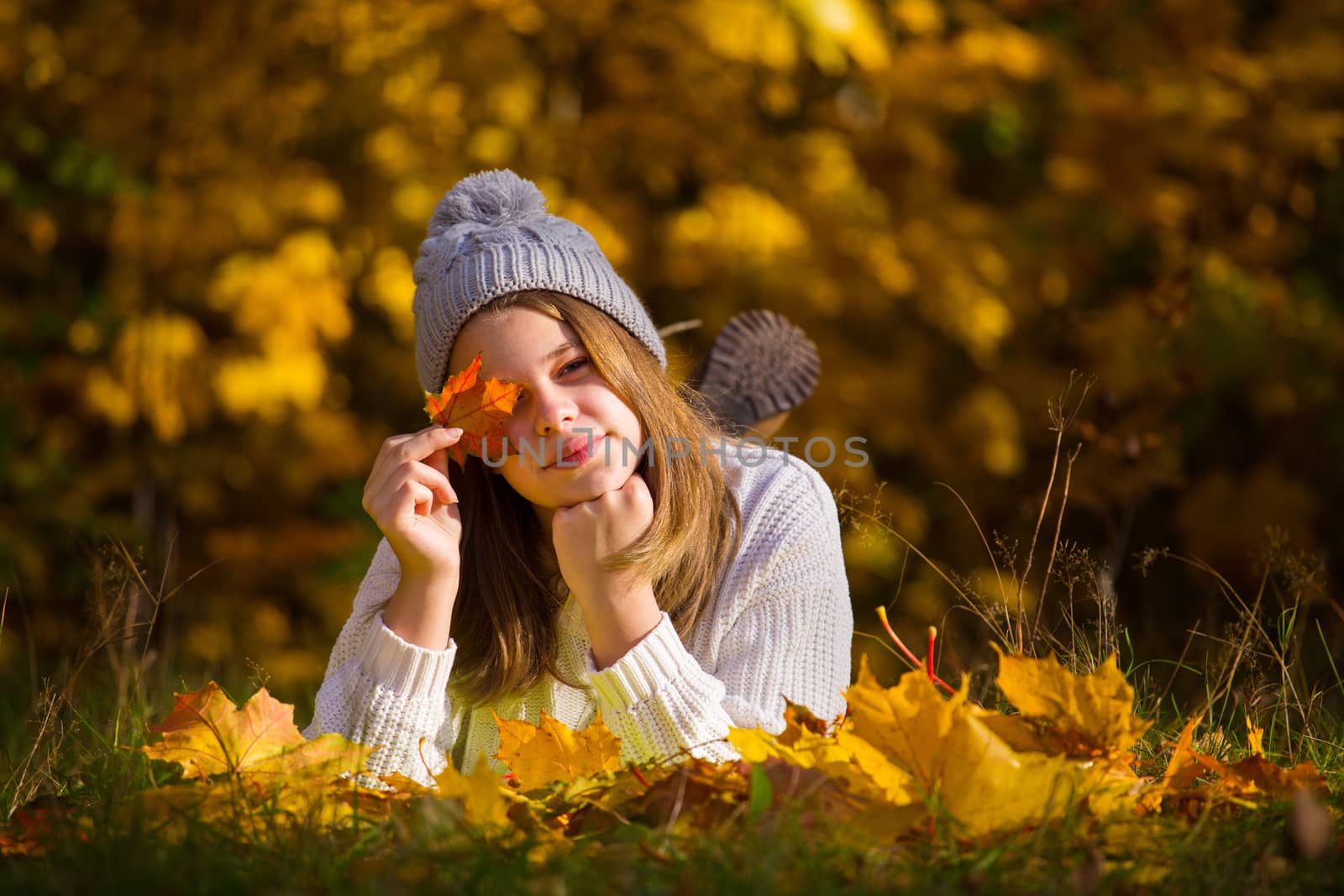 Portrait of pretty nice teenage girl in autumn park , background with copy space for text