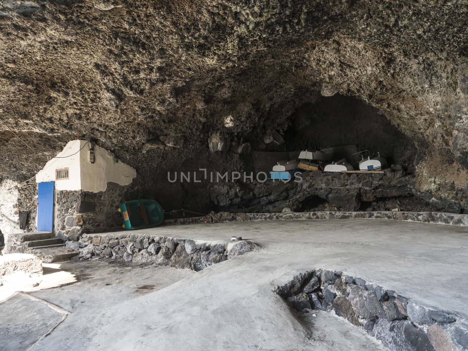 Stored wooden fishing boat at Cueva de Candelaria, Pirate cave Poris de Candelaria, small hidden fisherman village near Tijarafe, La Palma, Canary islands, Spain.