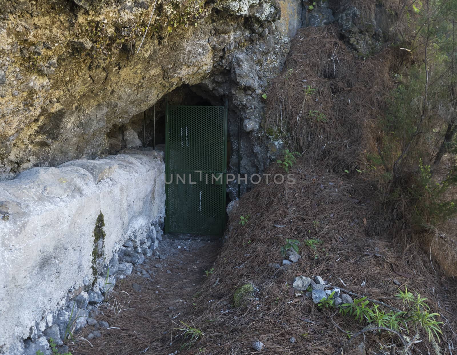 Closed iron doors to the tunnel at danger hiking trail Barranco de la Madera from Las Nieves, La Palma Island, Canary Islands, Spain.