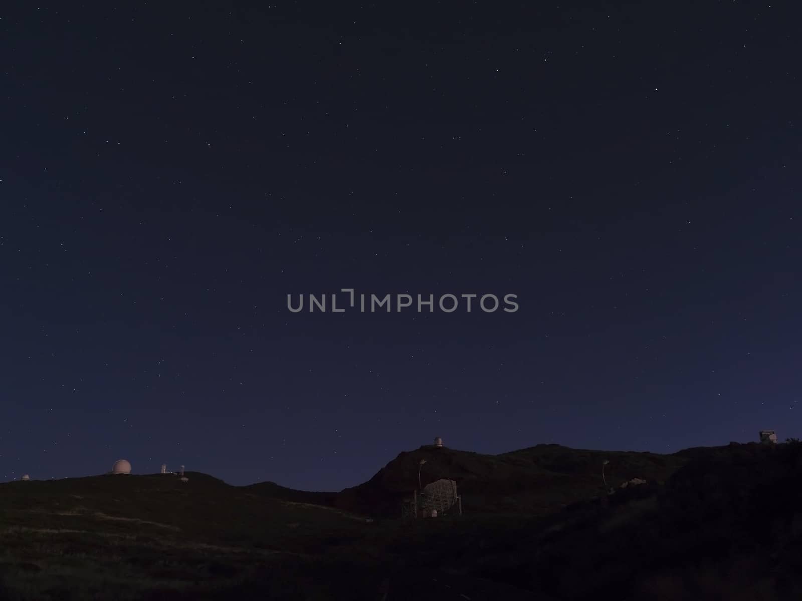 Night astrophotography, sky with stars at Roque de los Muchachos with telescopes of astronomical observatory, la Palma, Canary islands, Spain.