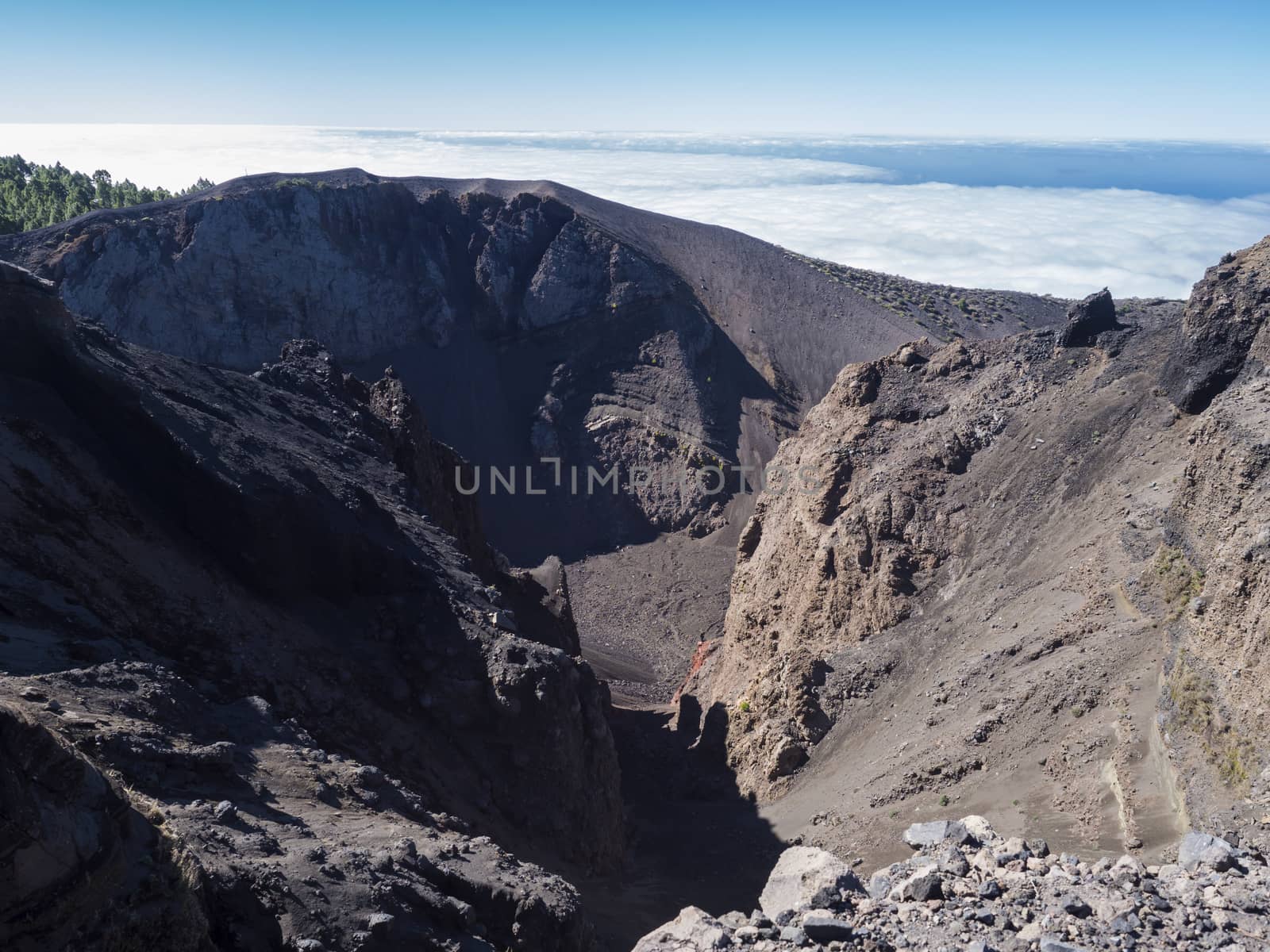 View to crater of volcano El Duraznero along the path Ruta de los Volcanes, beautiful hiking trail at La Palma island, Canary Islands, Spain, Blue sky background.