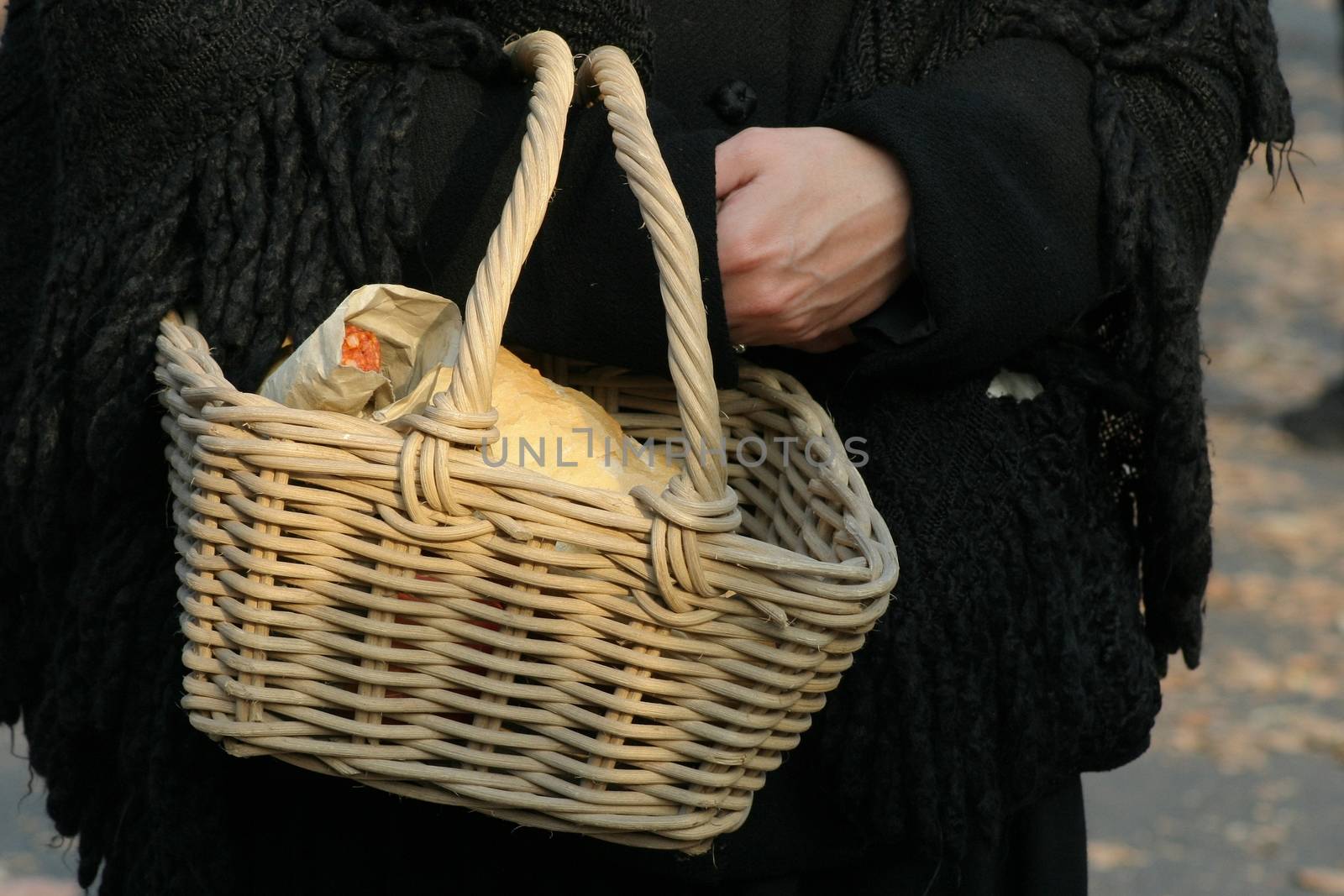 Food basket with bread and sausages.
