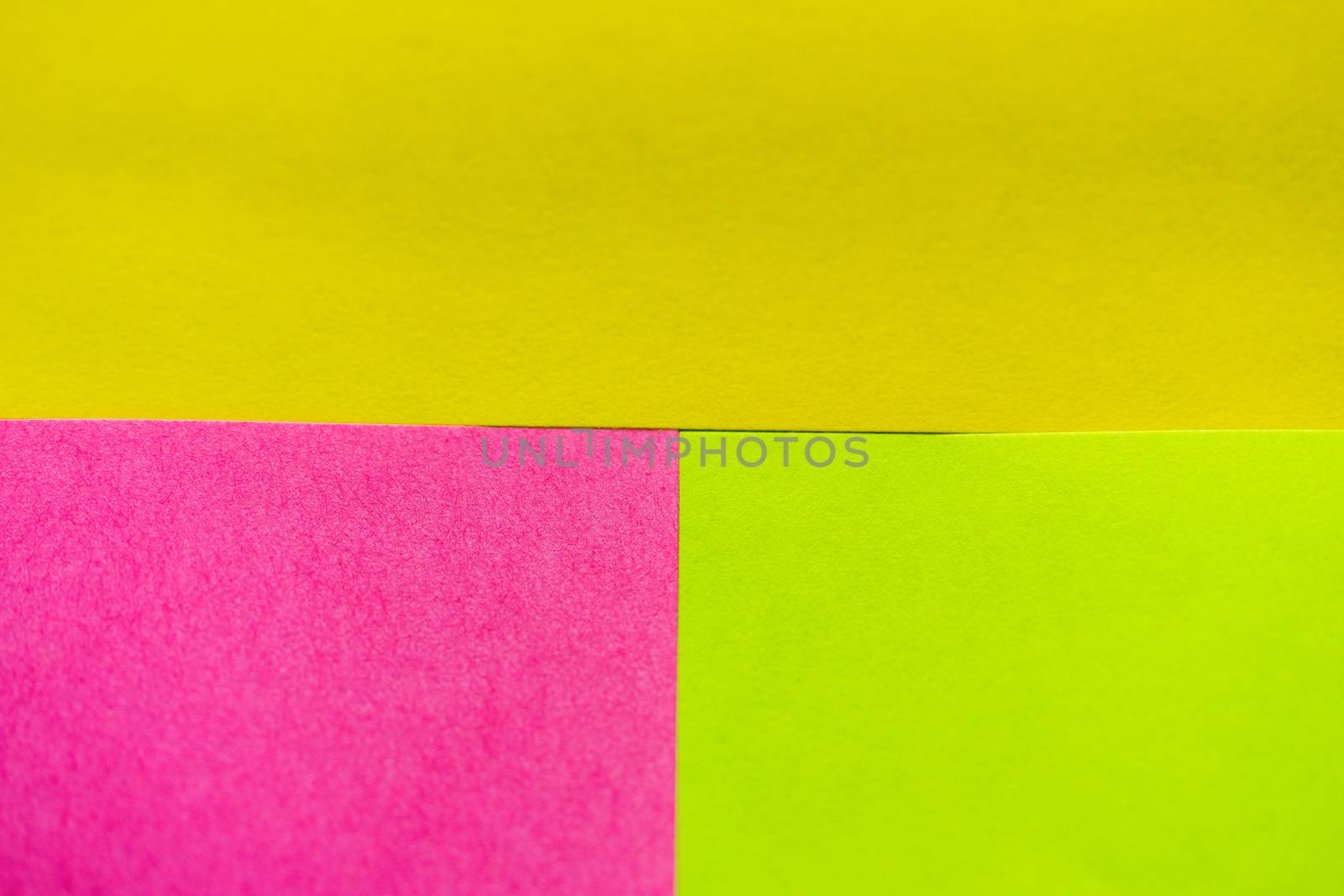 Yellow, green and pink paper pattern arranged in the background by ToonPhotoClub