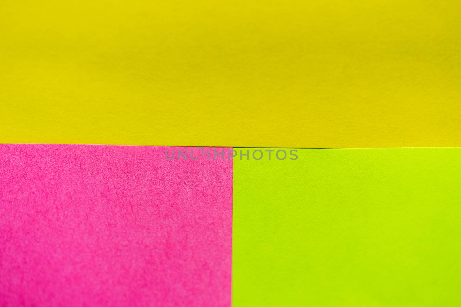 Yellow, green and pink paper pattern arranged in the background