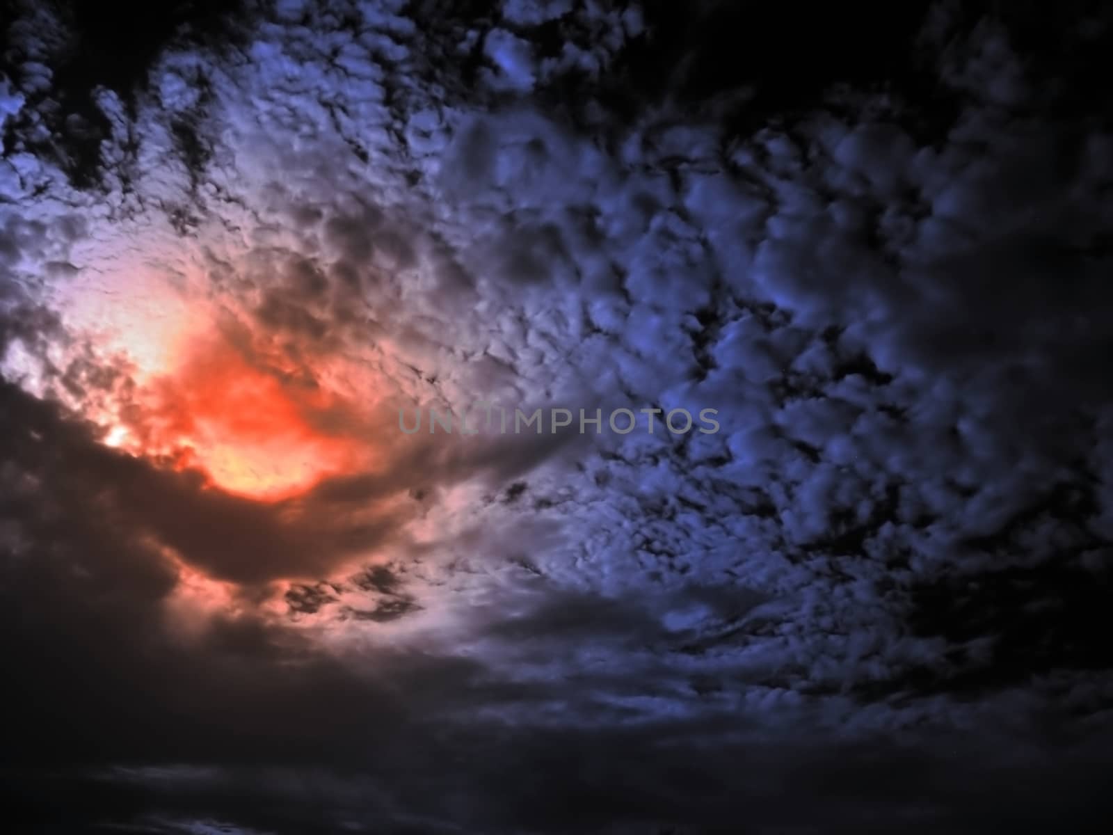 Red Sun Dawn behind Clouds