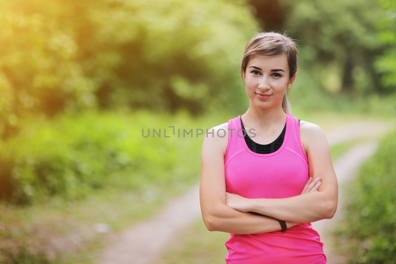Young fitness woman running in the morning forest trail. Motivation healthy fit living. Running shoe of the person running in nature with beautiful sunlight. Woman warming up before running