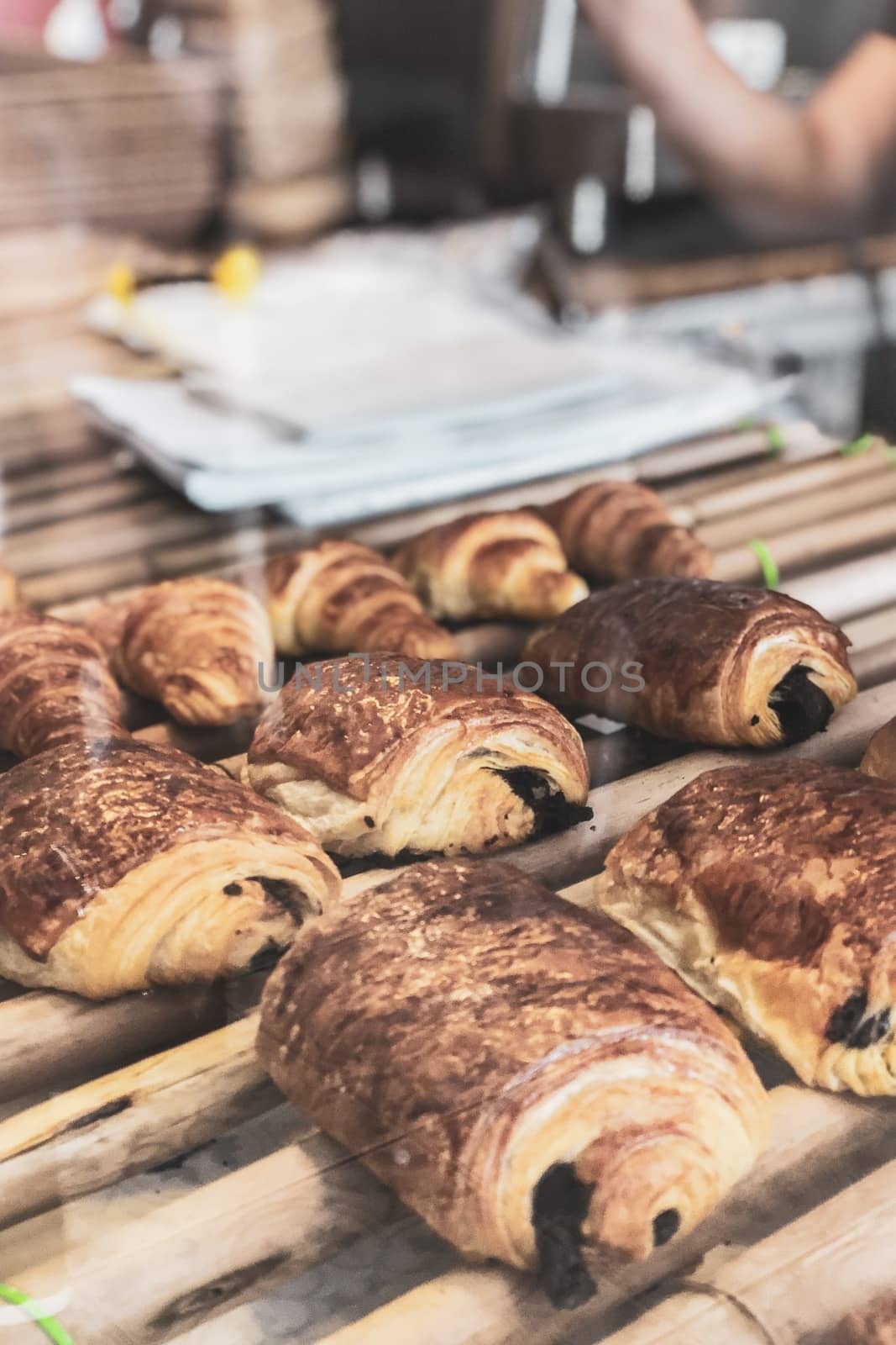 Freshly baked croissants on wooden board, top view.