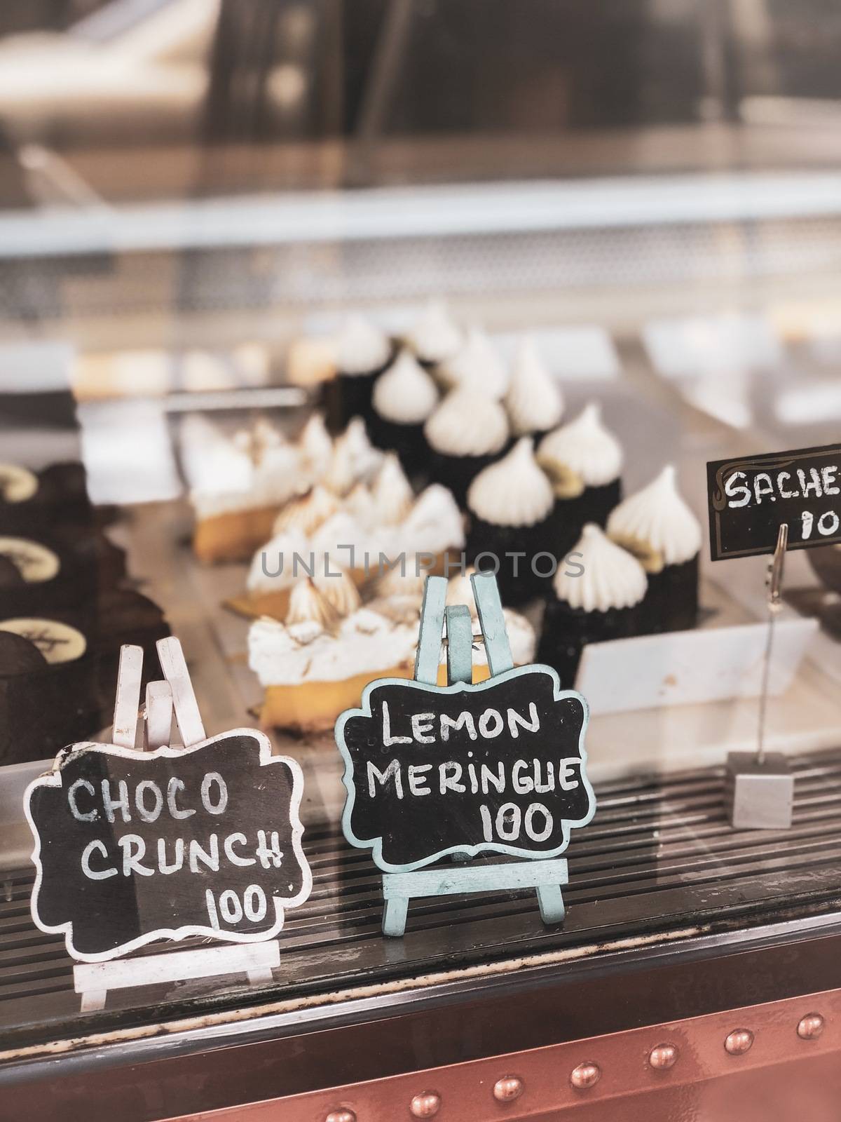 Pastry shop with variety dessert of choco crunch, lemon meringue.