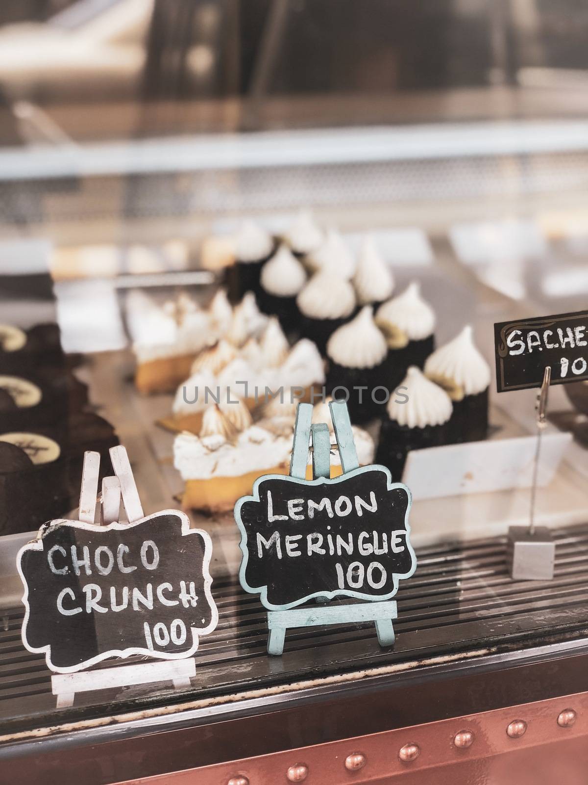 Pastry shop with variety dessert of choco crunch, lemon meringue by Benzoix