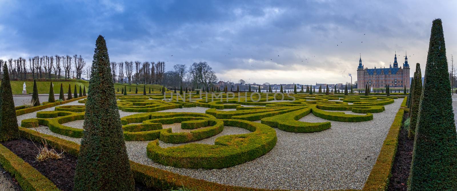 Frederiksborg castle , with ornamental landscape gardened shrubs in the foreground, Hillerod, Denmark
