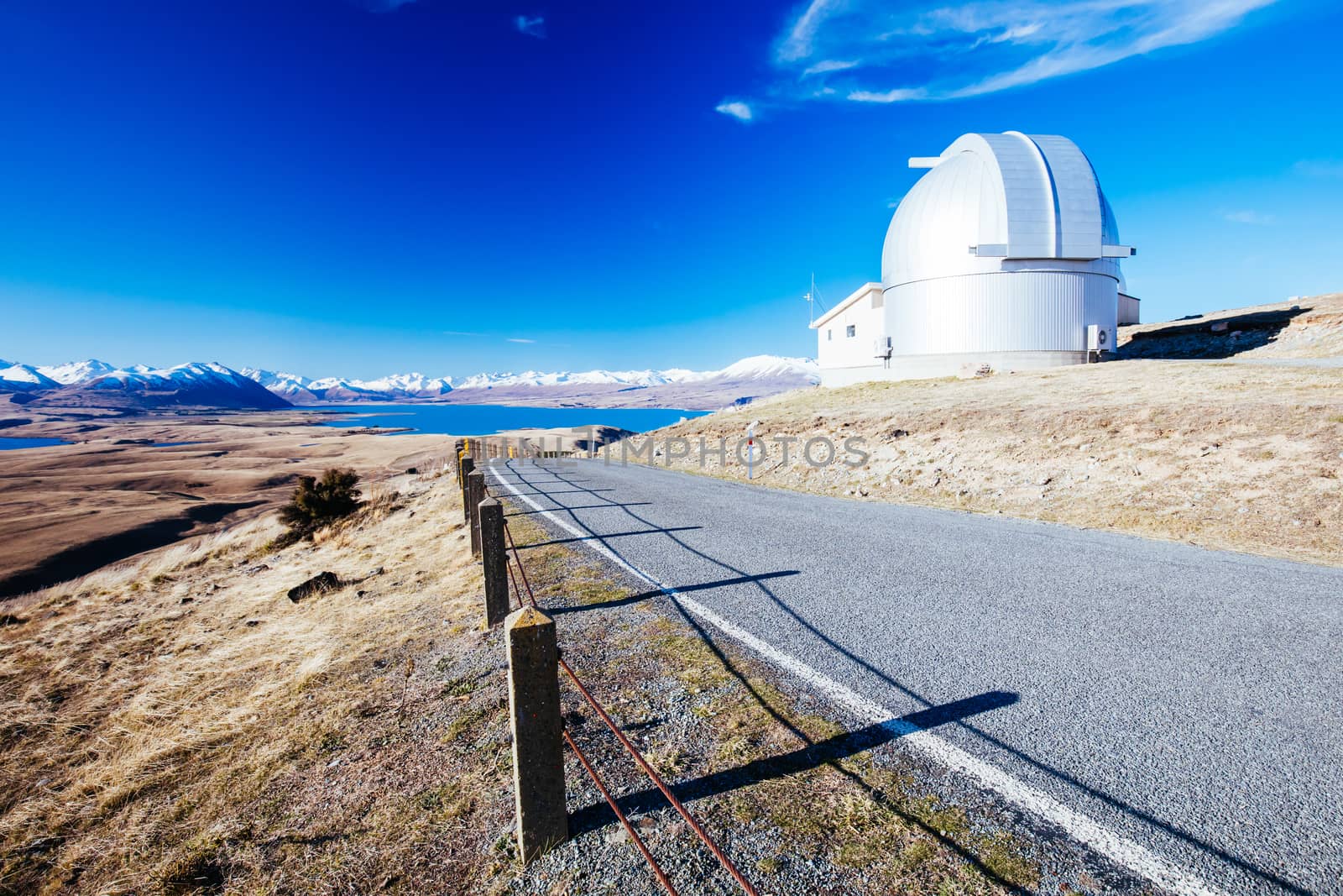 The view of the southern alps and Lake Alexandrina from Mt John Walkway and observatory area near Lake Tekapo on a clear spring evening in New Zealand