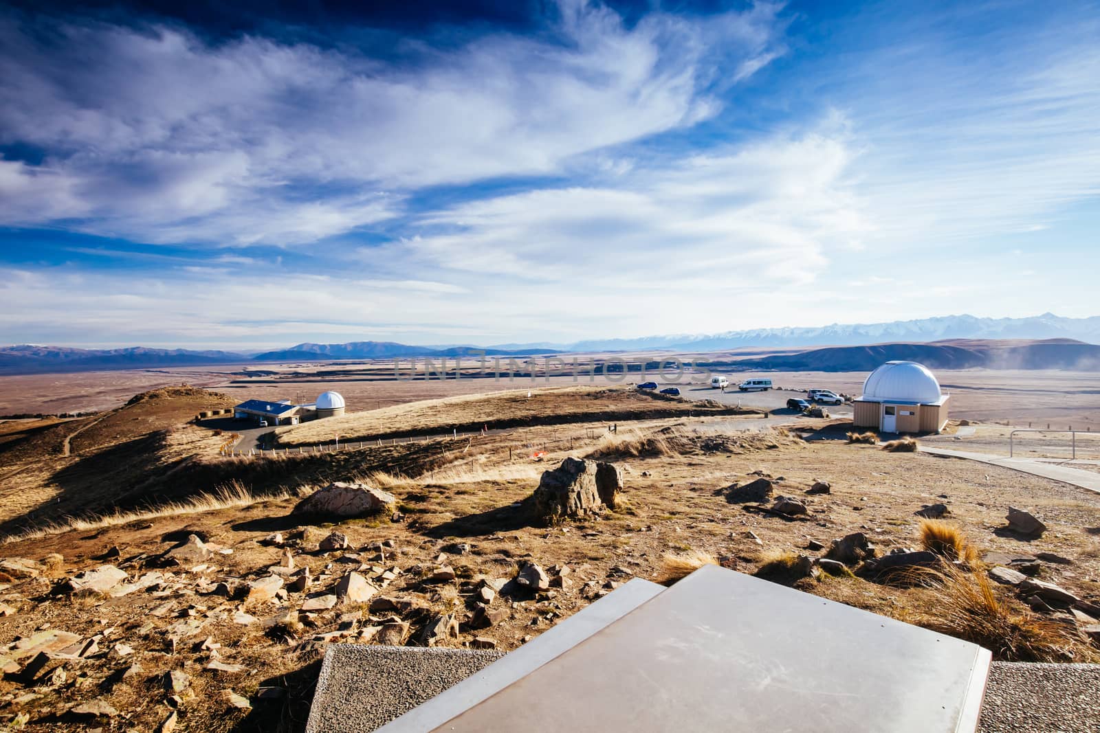 The view of the southern alps and Lake Alexandrina from Mt John Walkway and observatory area near Lake Tekapo on a clear spring evening in New Zealand