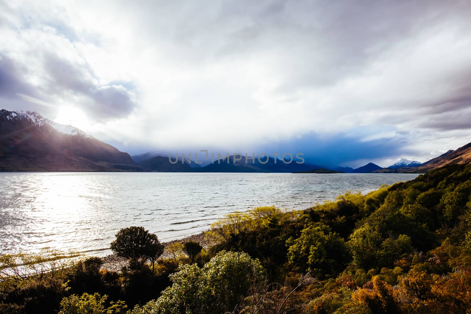 Lake Wakatipu and surrounding mountains, including Tooth Peaks from near Bennetts Bluff Lookout, on a sunny spring day approaching sunset near Glenorchy in New Zealand