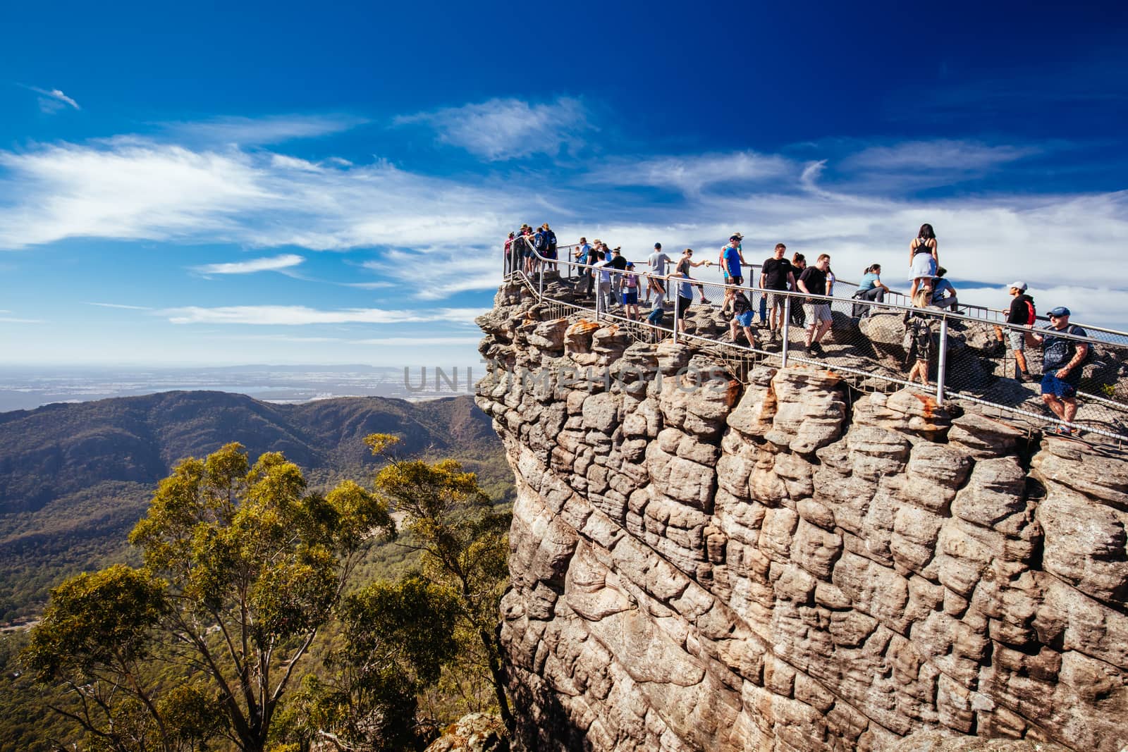 Crowds take in the iconic views from Pinnacle Lookout over Halls Gap and surrounds on the Wonderland hike loop in Victoria, Australia