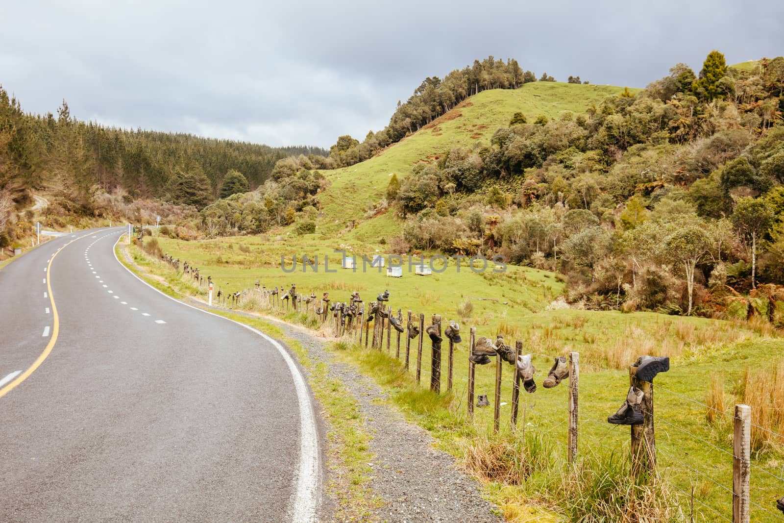 Tramping boots are laid out on a fence along Te Anga Rd near Waitomo in New Zealand