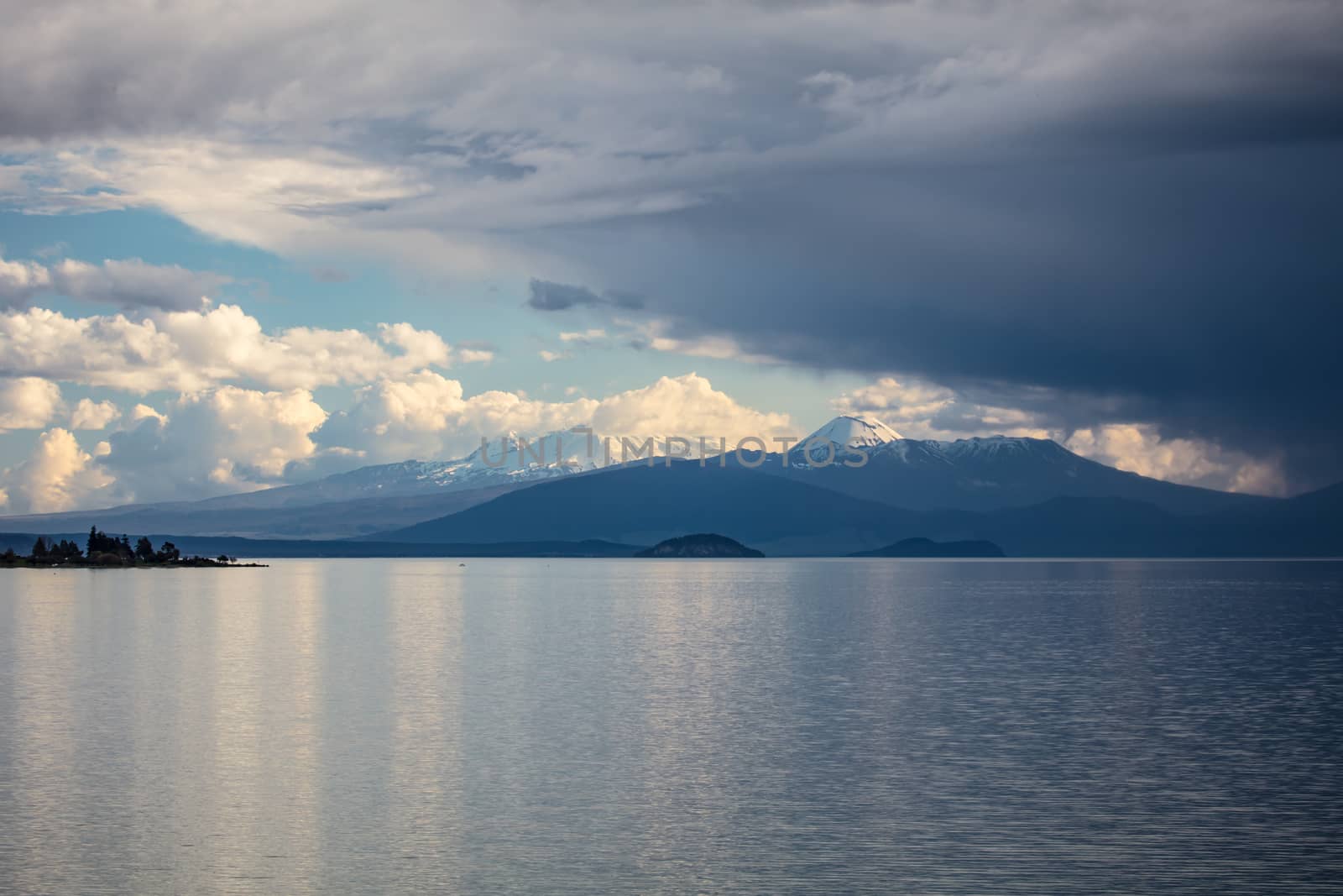 Storms rolling in over Tongariro National Park. The peaks of Mt Ruapehu and Mt Ngaurhoe can be seen at sunset in New Zealand