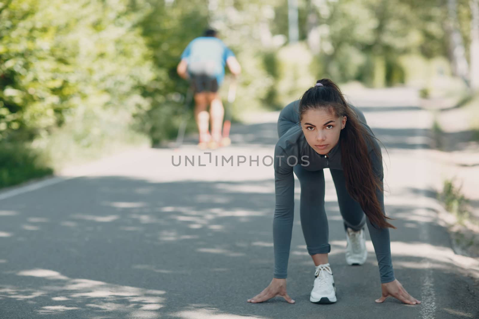 Start to run. Running girl in treadmill city park. Young woman runner outdoor jogging. by primipil