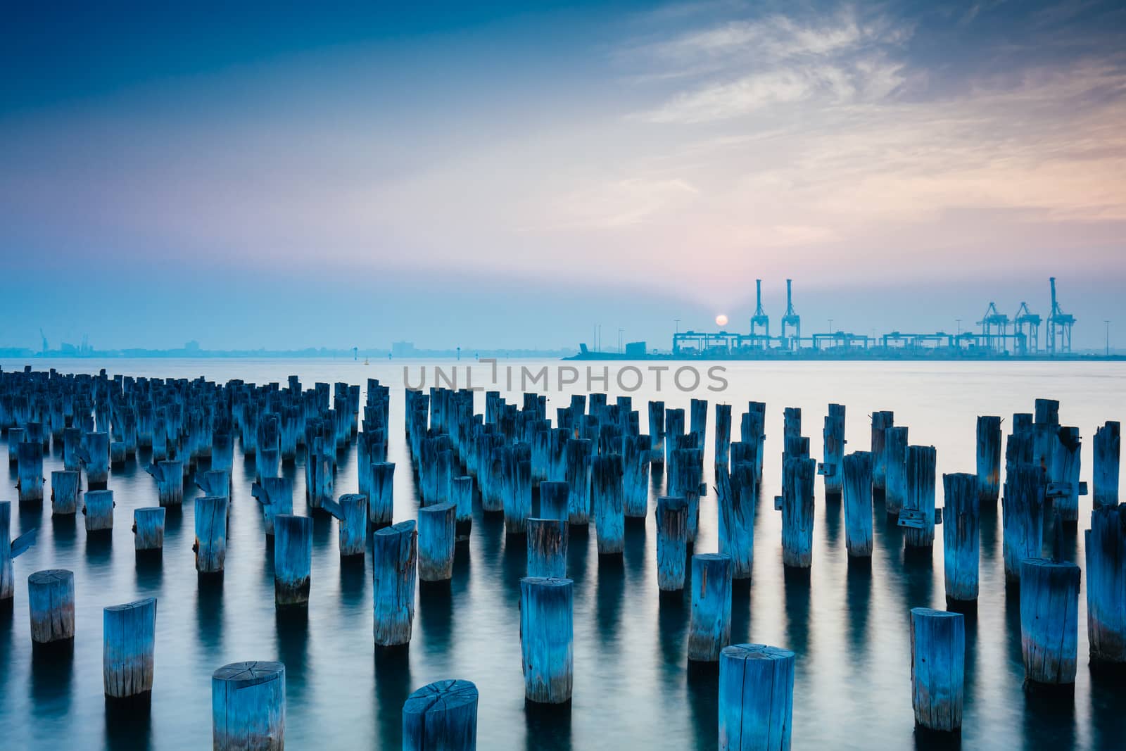 The historic Princes Pier featuring many disused pylons on a hot summer's day in Port Melbourme, Australia